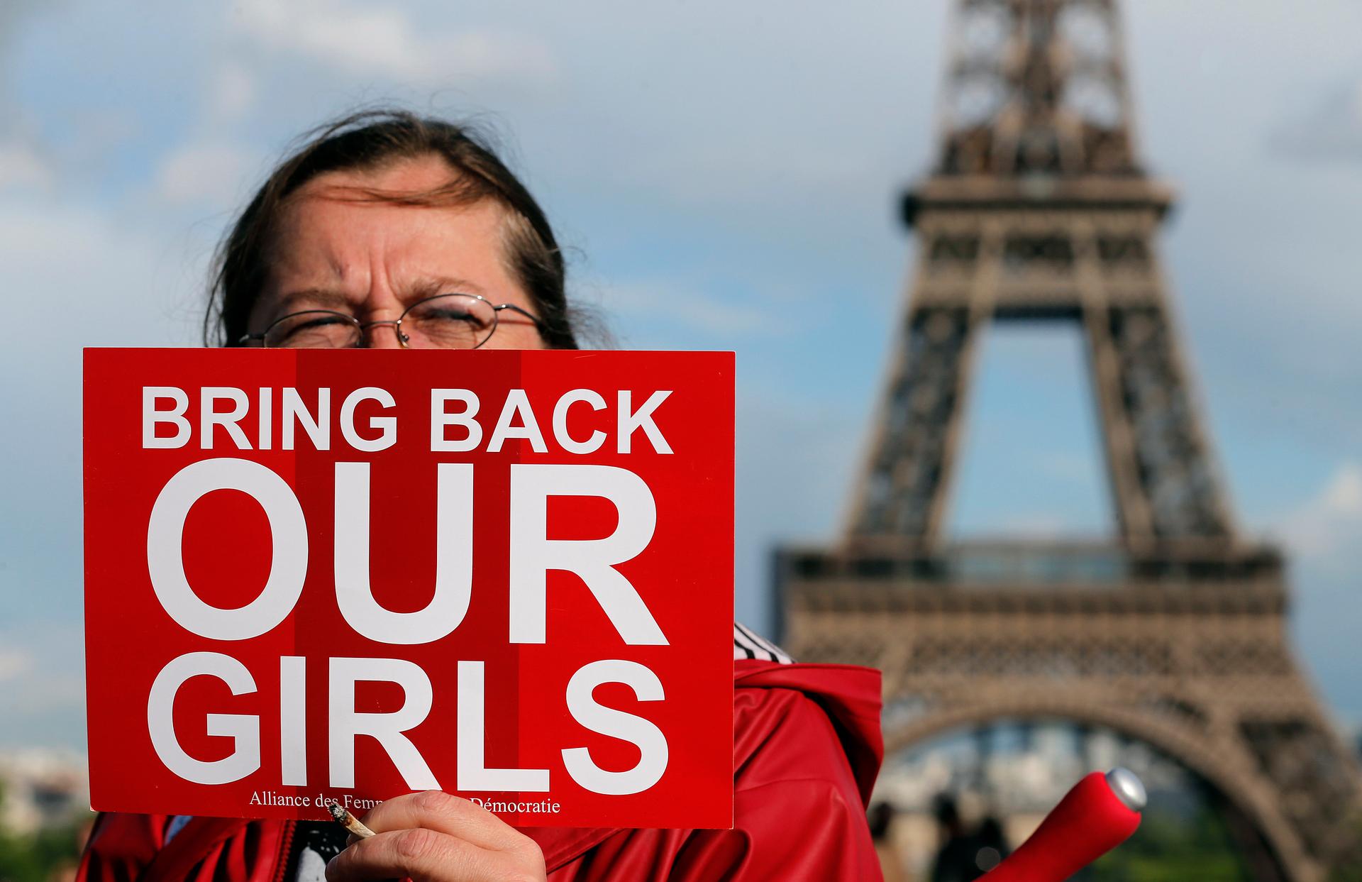 A protester at Trocadero Square near the Eiffel Tower in Paris demonstrates against  the kidnapping of school girls in Nigeria.