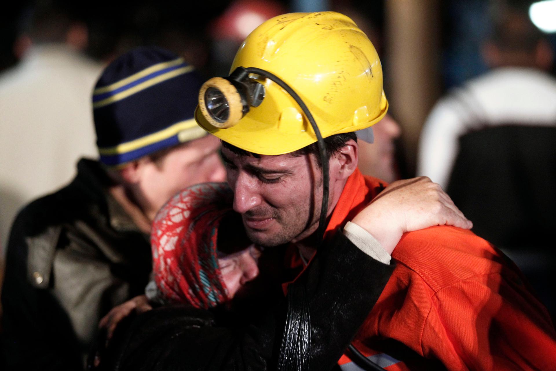 A miner hugs a relative in front of a coal mine in Soma, Turkey, after the country's worst mining accident in more than two decades.