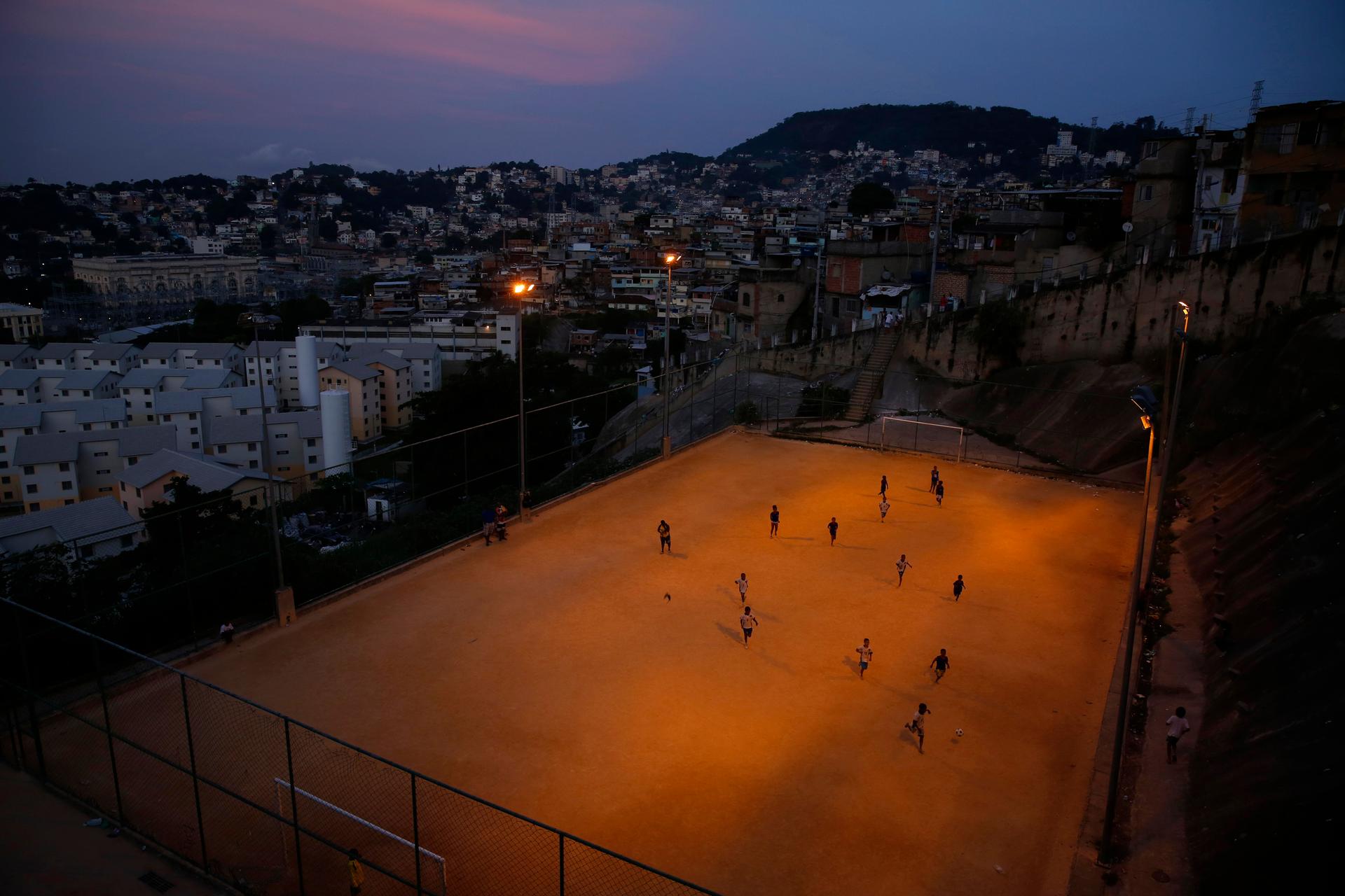 Kids play soccer during a training session at Sao Carlos slum in Rio de Janeiro May 15, 2014.
