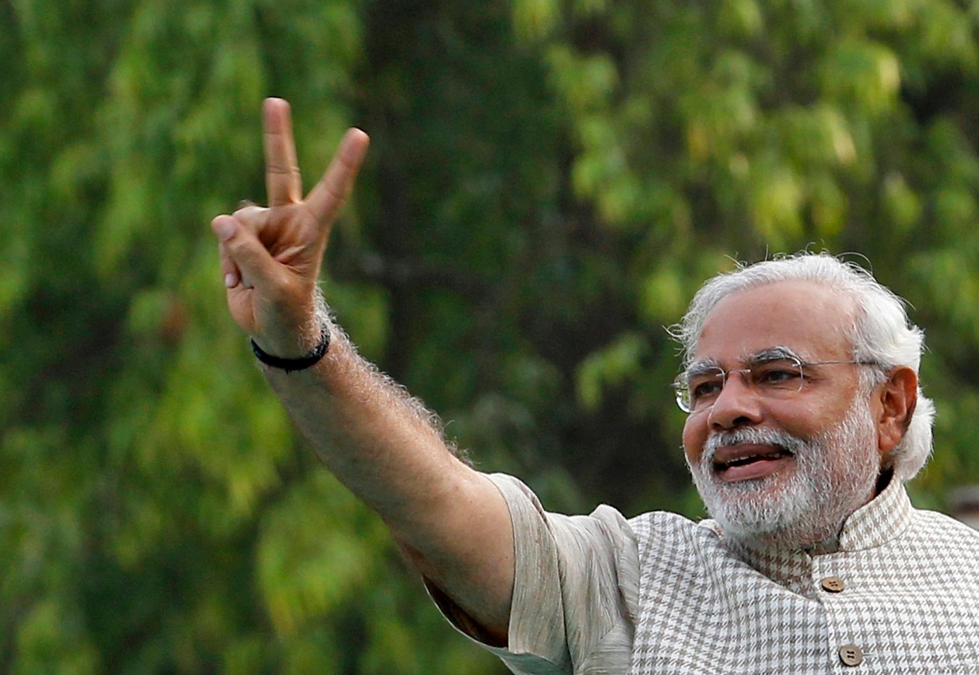 Narendra Modi gives a victory sign at a rally in his home state of Gujarat, Friday. Modi will be India's next Prime Minister after decisively winning parliamentary elections.