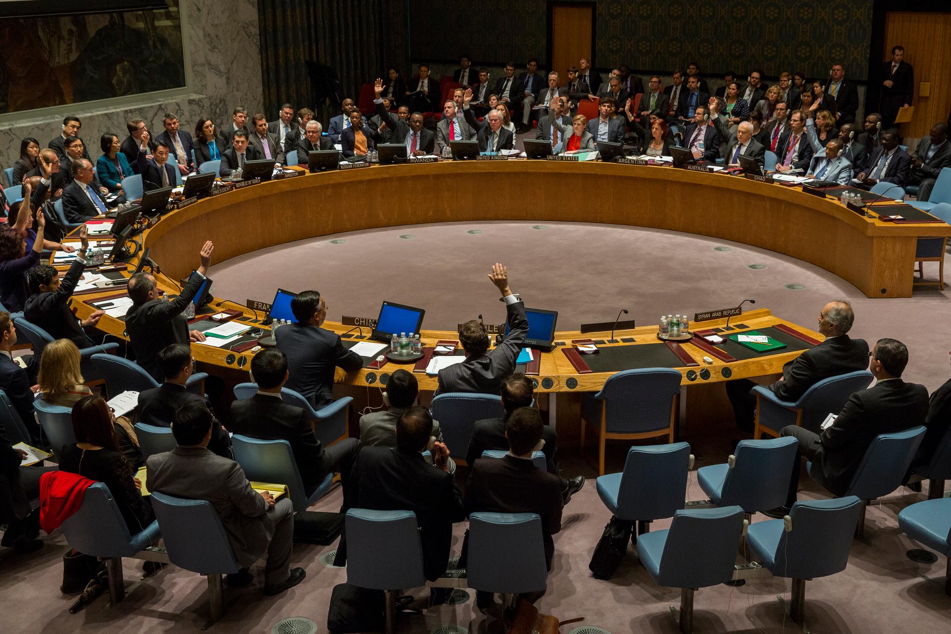 All members with the exception of Russia's UN Ambassador Vitaly Churkin and China's deputy U.N. Ambassador Wang Min vote in the United Nations Security Council in favor of referring the Syrian crisis to the International Criminal Court for investigation o