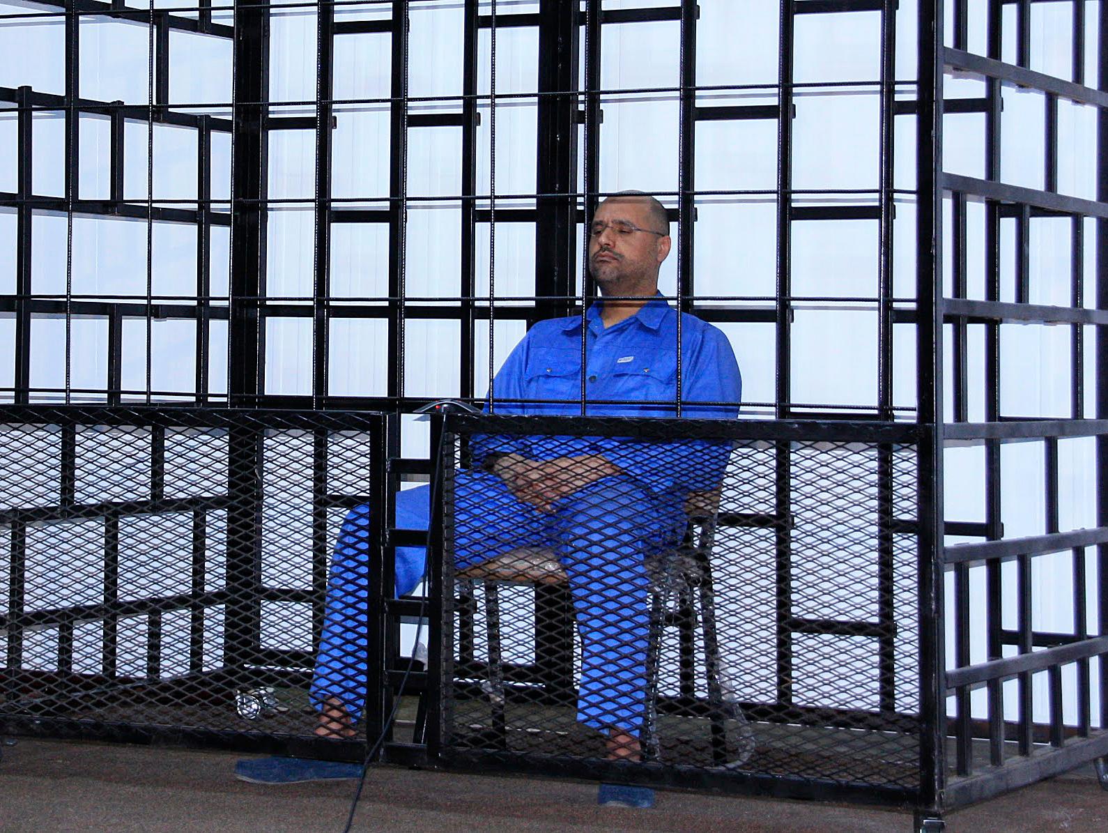 Saif al-Islam Gaddafi attending a hearing at the beginning of his trial in 2014. Here he’s seen in a courtroom in Zintan, linked via video to the actual trial in the capital, Tripoli.