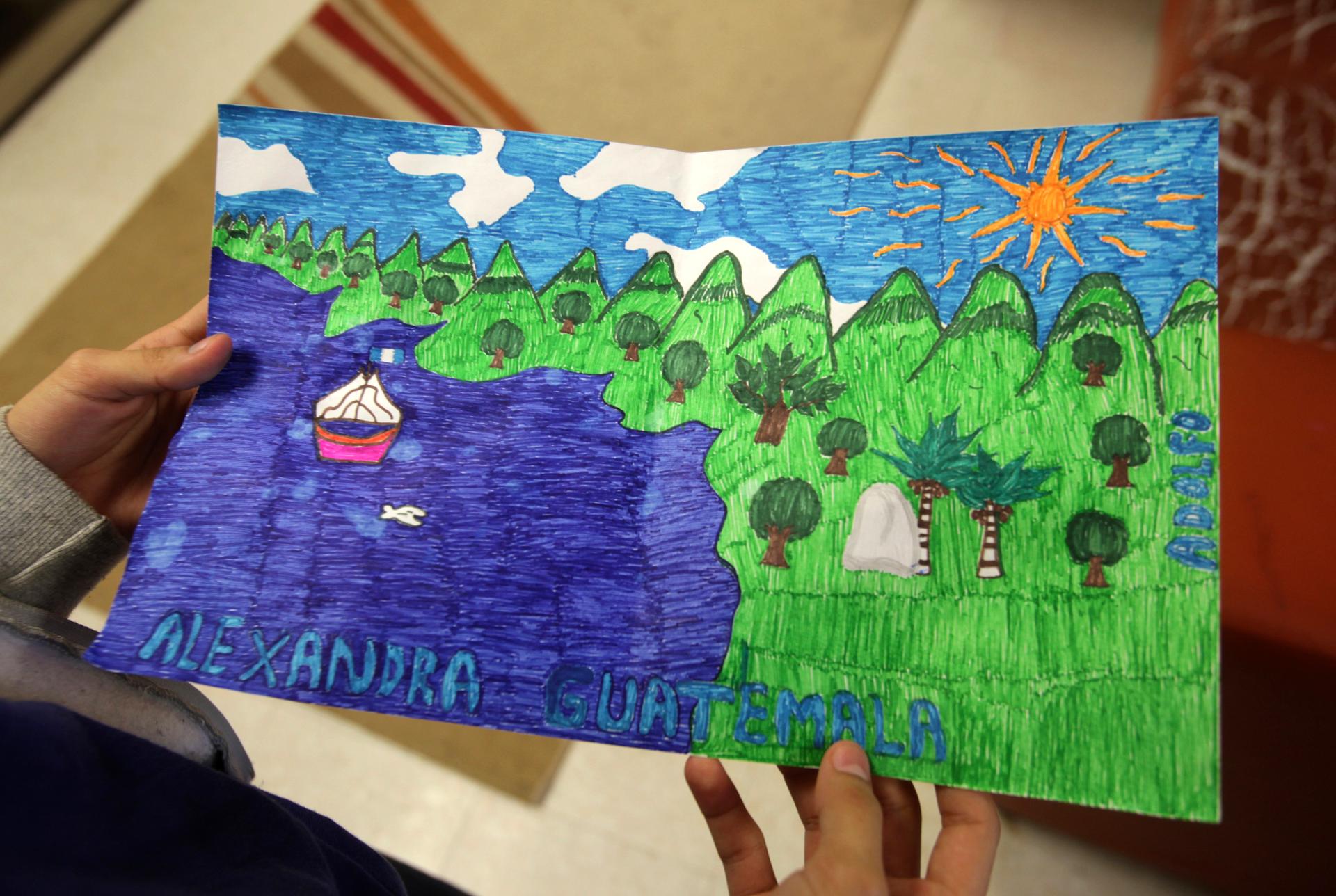Alexandra from Guatemala shows a drawing she made at the shelter for underage immigrants and repatriated minors