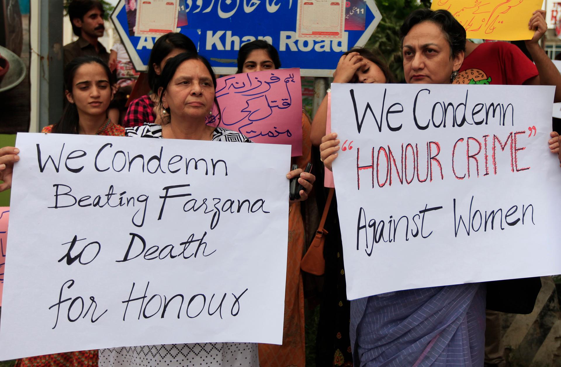 Members of civil society and the Human Rights Commission of Pakistan hold placards during a protest in Islamabad May 29, 2014 against the killing of Farzana Iqbal, 25, by family members on Tuesday in Lahore. 