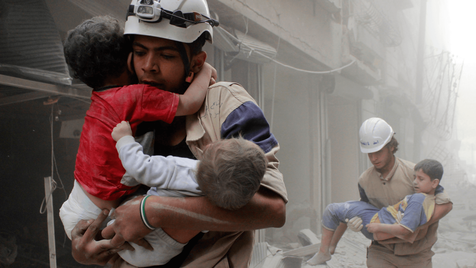 Members of the civil defense rescue children after what activists said was an air strike by forces loyal to Syria's President Bashar al-Assad in al-Shaar neighborhood of Aleppo.