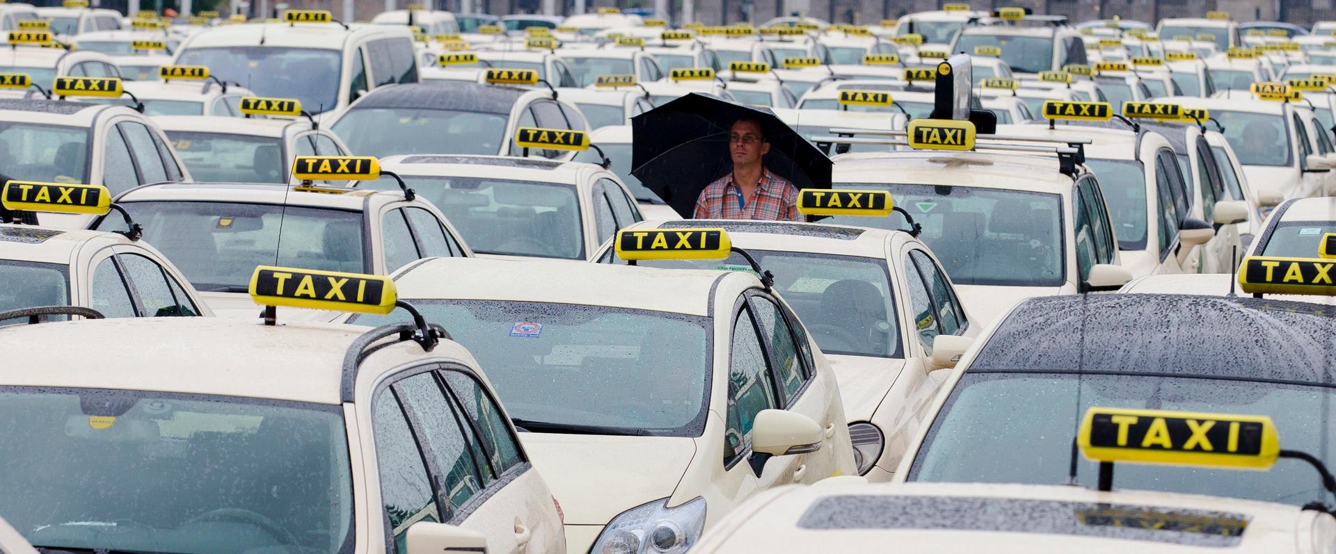 A man attends an Europe-wide protest of licensed taxi drivers against ride hailing apps, like Uber, they fear will allow unregulated, private drivers into the market, in front of the Olympic stadium in Berlin, June 11, 2014.