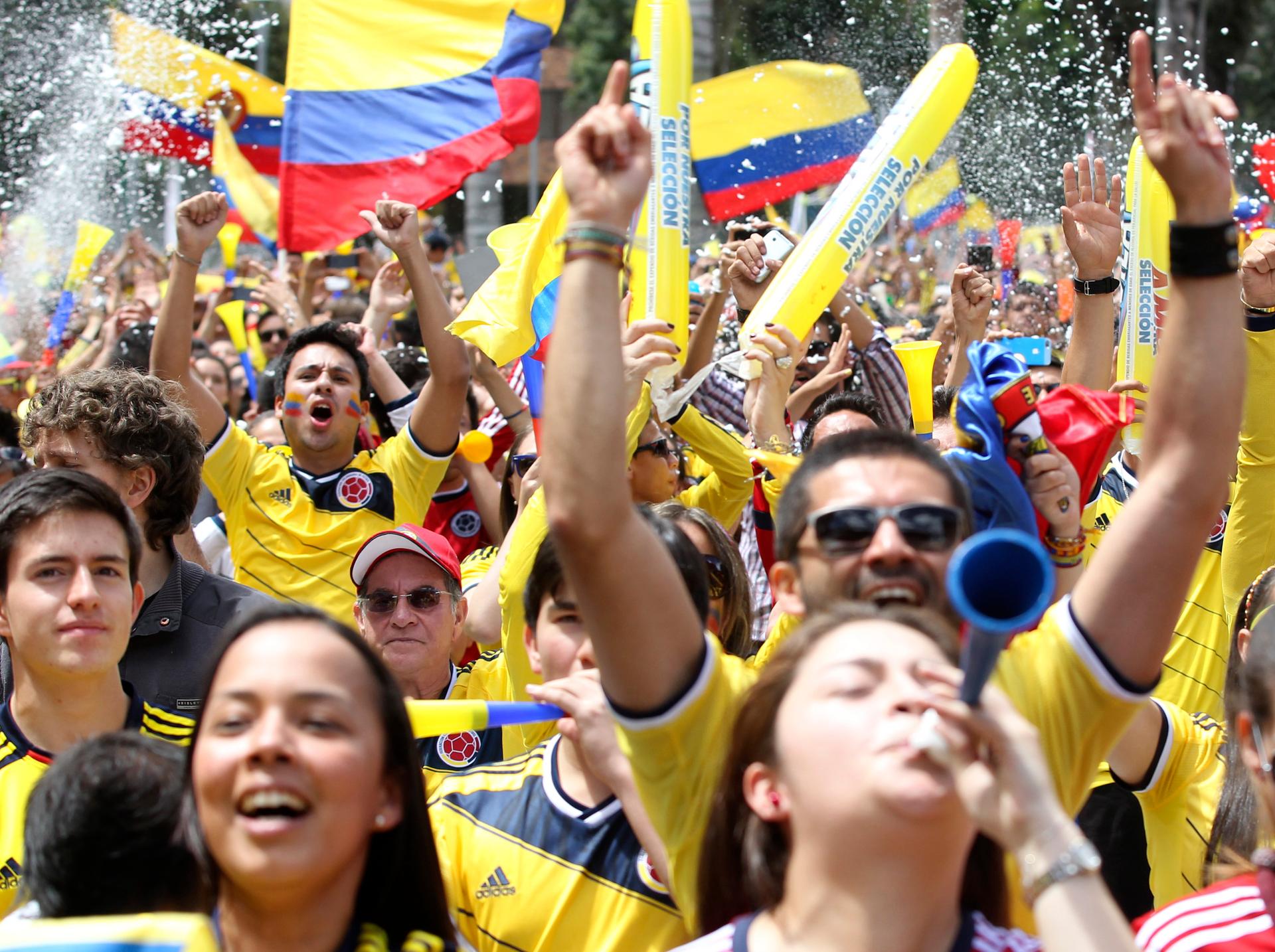 Colombia fans celebrate as they gather before the World Cup Group C soccer match between Colombia and Greece. After the 3-0 win, nine Colombians died in the alcohol-fueled postgame parties.