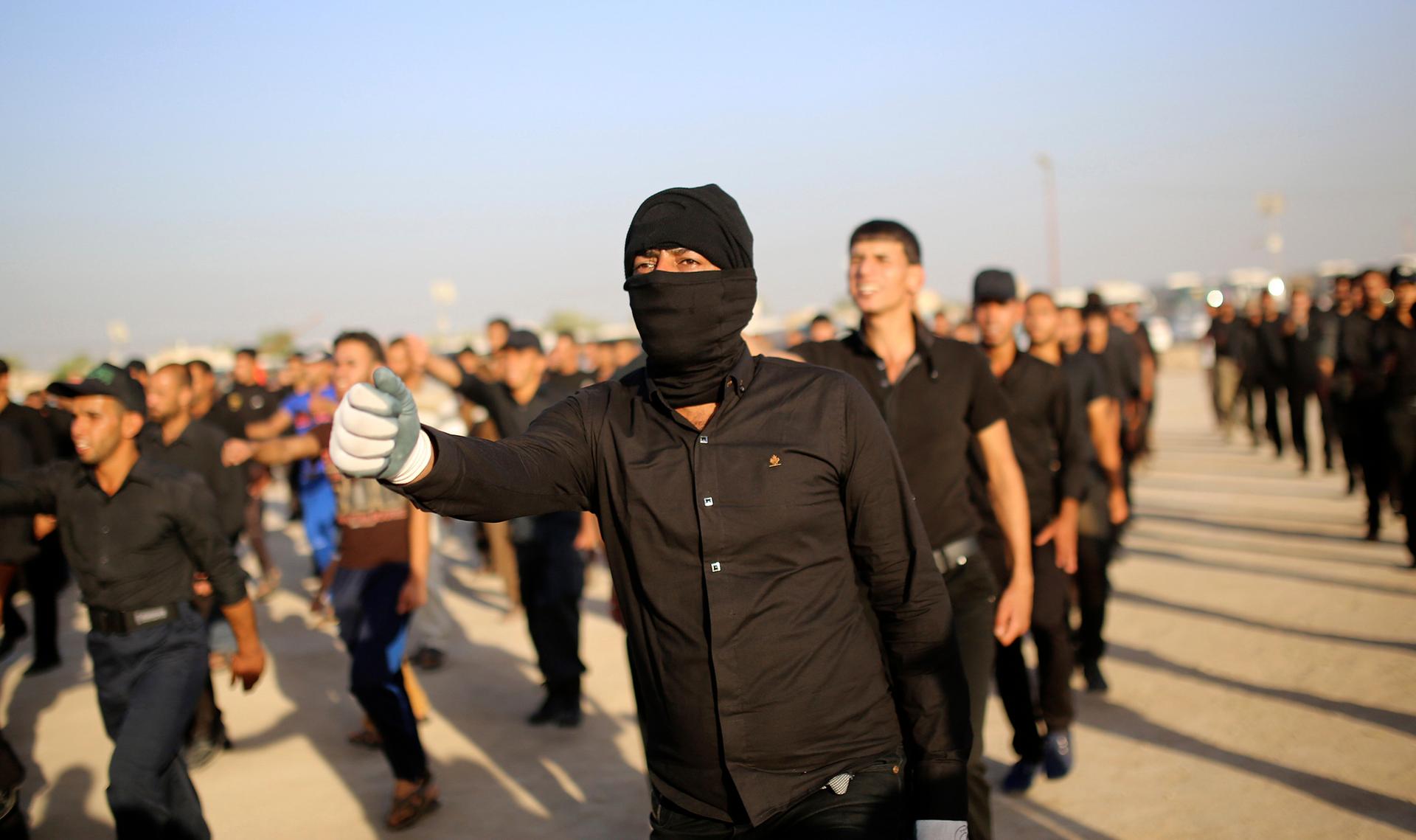Mehdi Army fighters loyal to Shiite cleric Moqtada al-Sadr march during a military-style training in the holy city of Najaf, June 16, 2014.