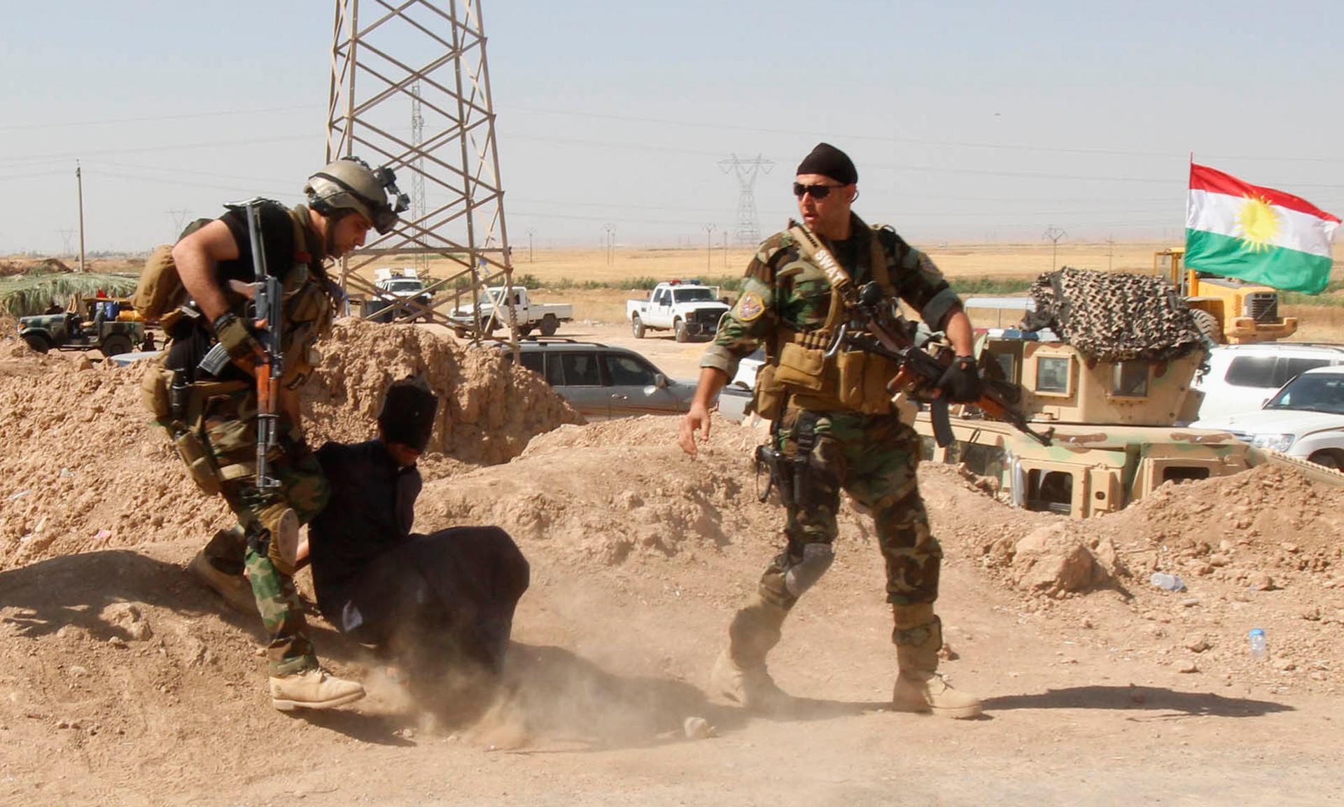 Kurdish security forces in Iraq detain a man suspected of being a militant belonging to the al-Qaeda-linked Islamic State in Iraq and Syria (ISIS), June 16, 2014. Iraq's Shiite rulers defied Western calls to reach out to Sunnis to defuse the ISIS uprising