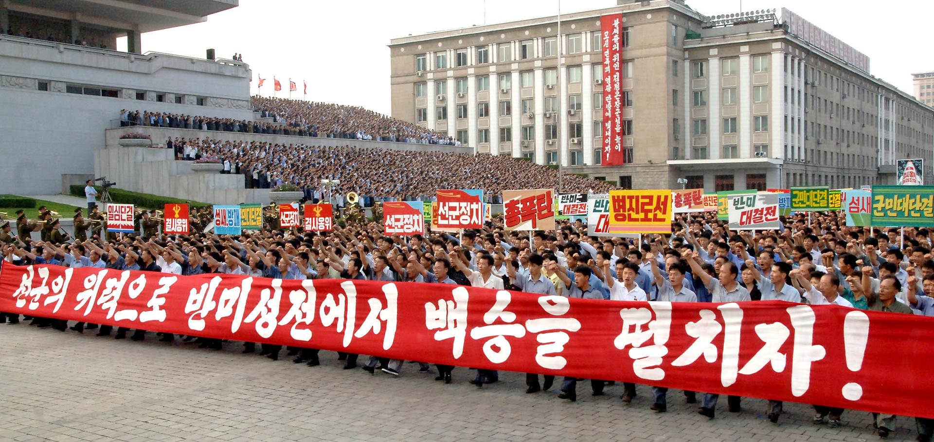 People attend a mass rally against "U.S. Imperialists" at Kim Il Sung Square in Pyongyang in this undated photo released by North Korea's Korean Central News Agency (KCNA) in Pyongyang June 25, 2014.