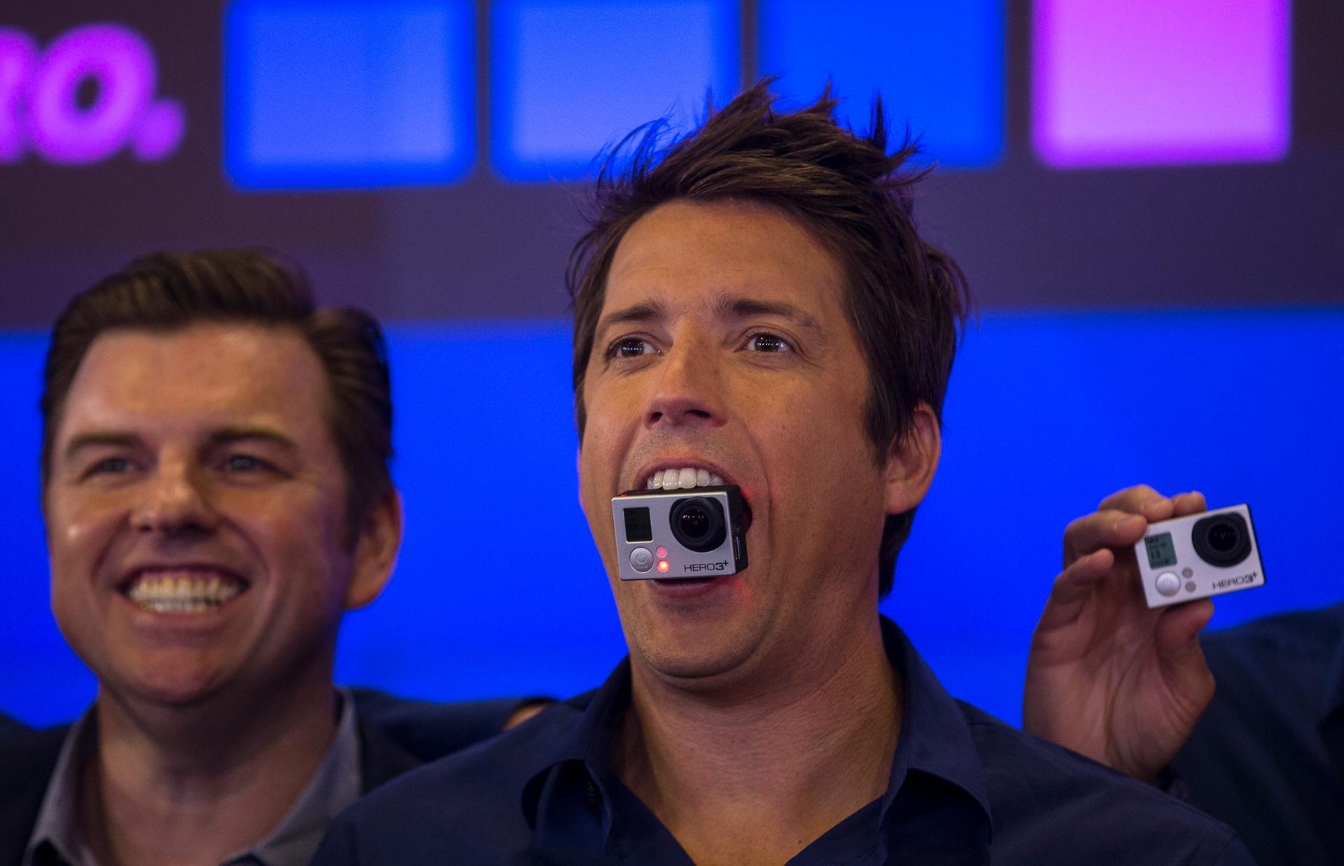 GoPro founder and CEO Nick Woodman holds a GoPro camera in his mouth as he celebrates the company's IPO at the Nasdaq Market Site in New York on June 26, 2014. 