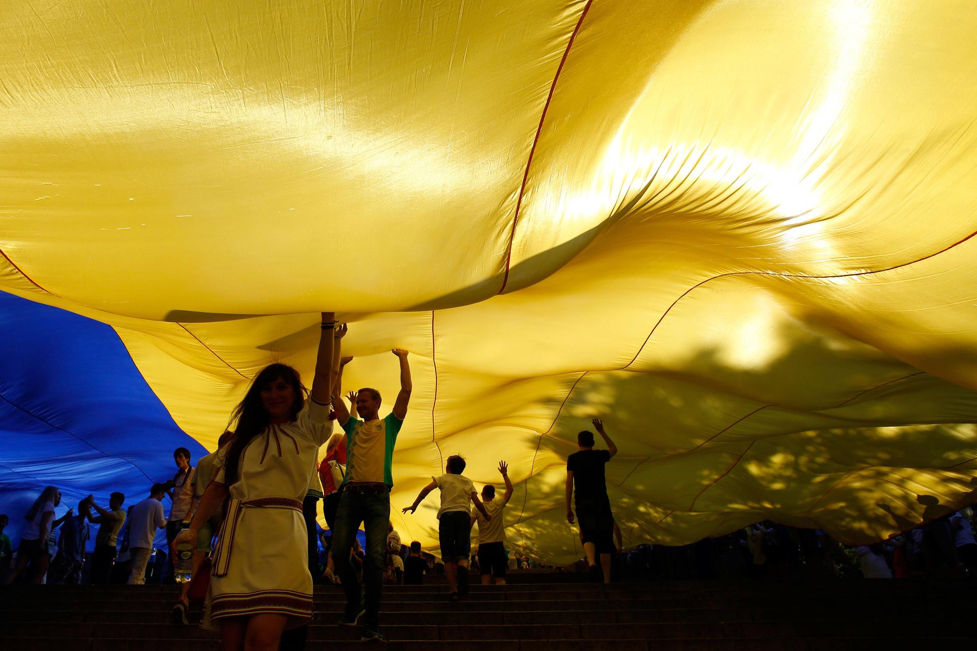 Youth unfurl a giant Ukrainian flag as part of celebrations to mark Constitution Day on the Potemkin Stairs in Odessa.