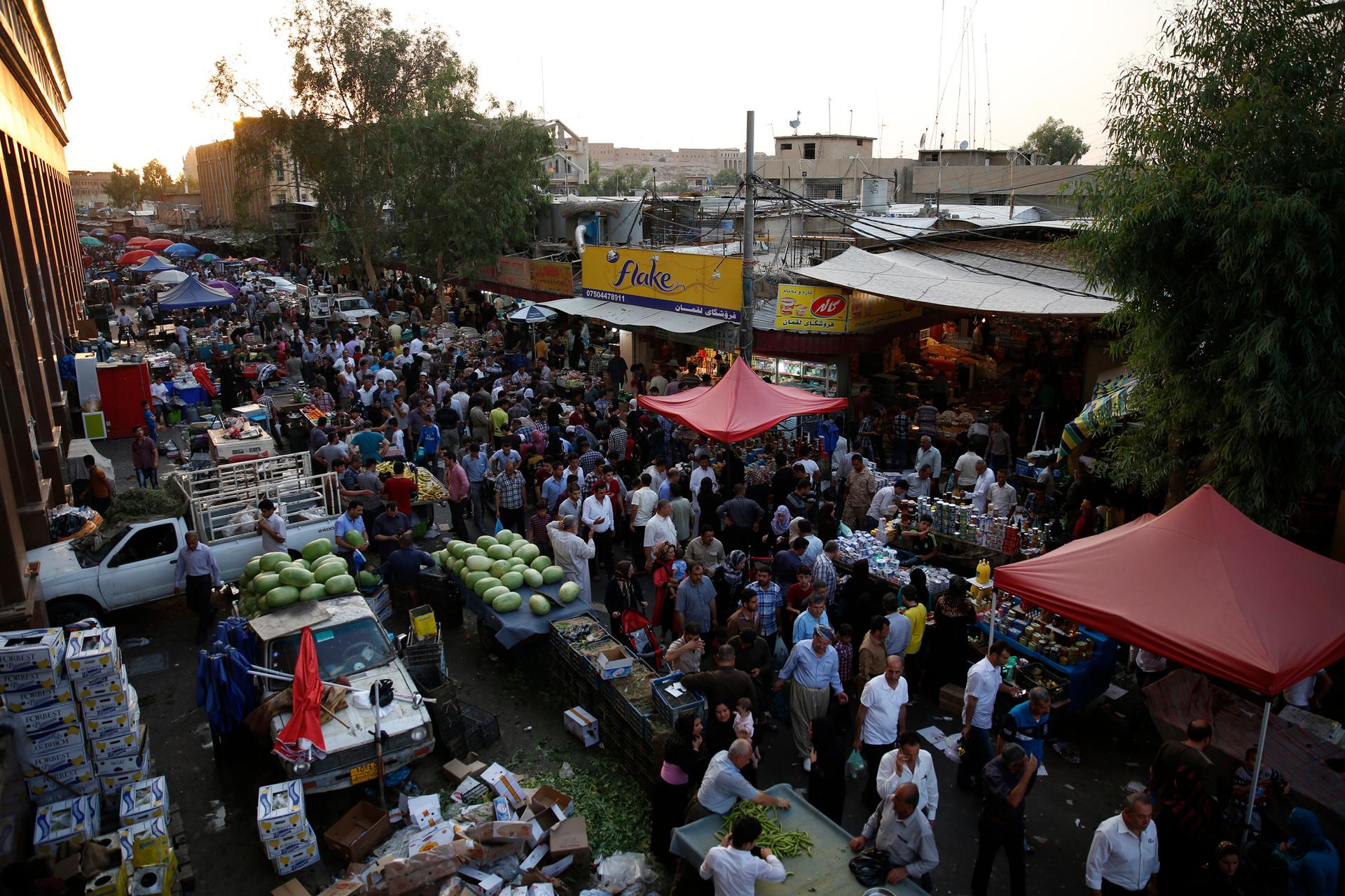 Residents of Erbil buy groceries in a local market. 
