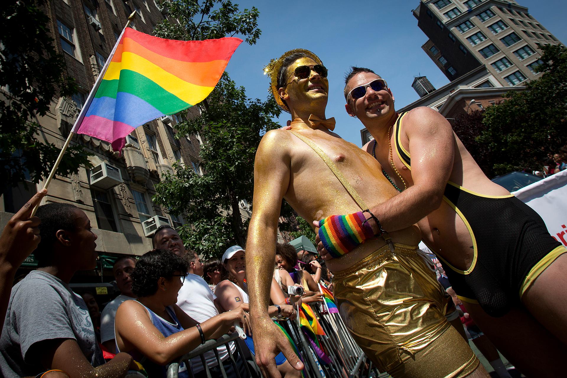 Men hug as they take part in the annual Gay Pride Parade on Christopher Street in the Manhattan borough of New York June 29, 2014.