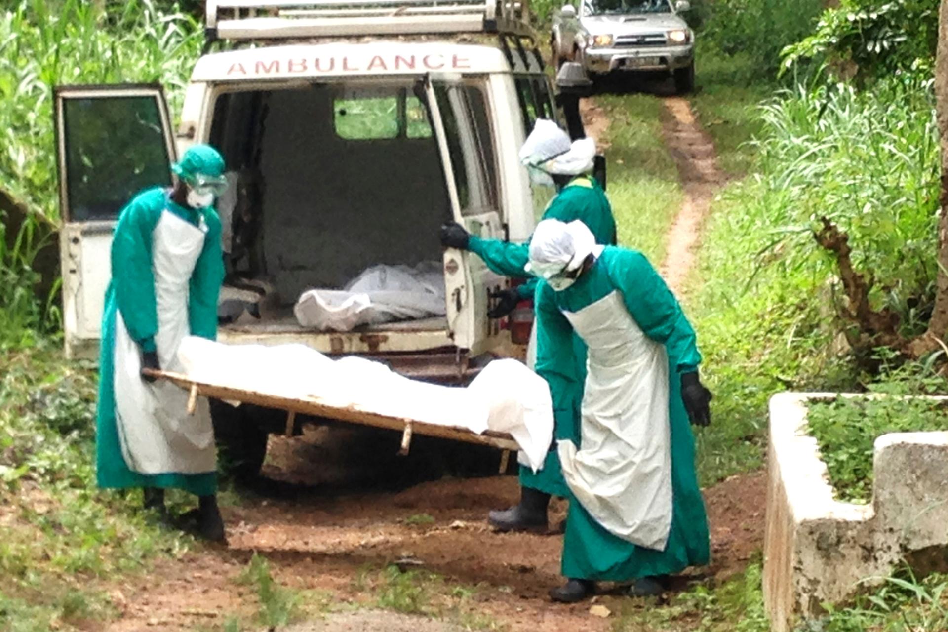 Health workers carry the body of an ebola virus victim in Kenema, Sierra Leone.
