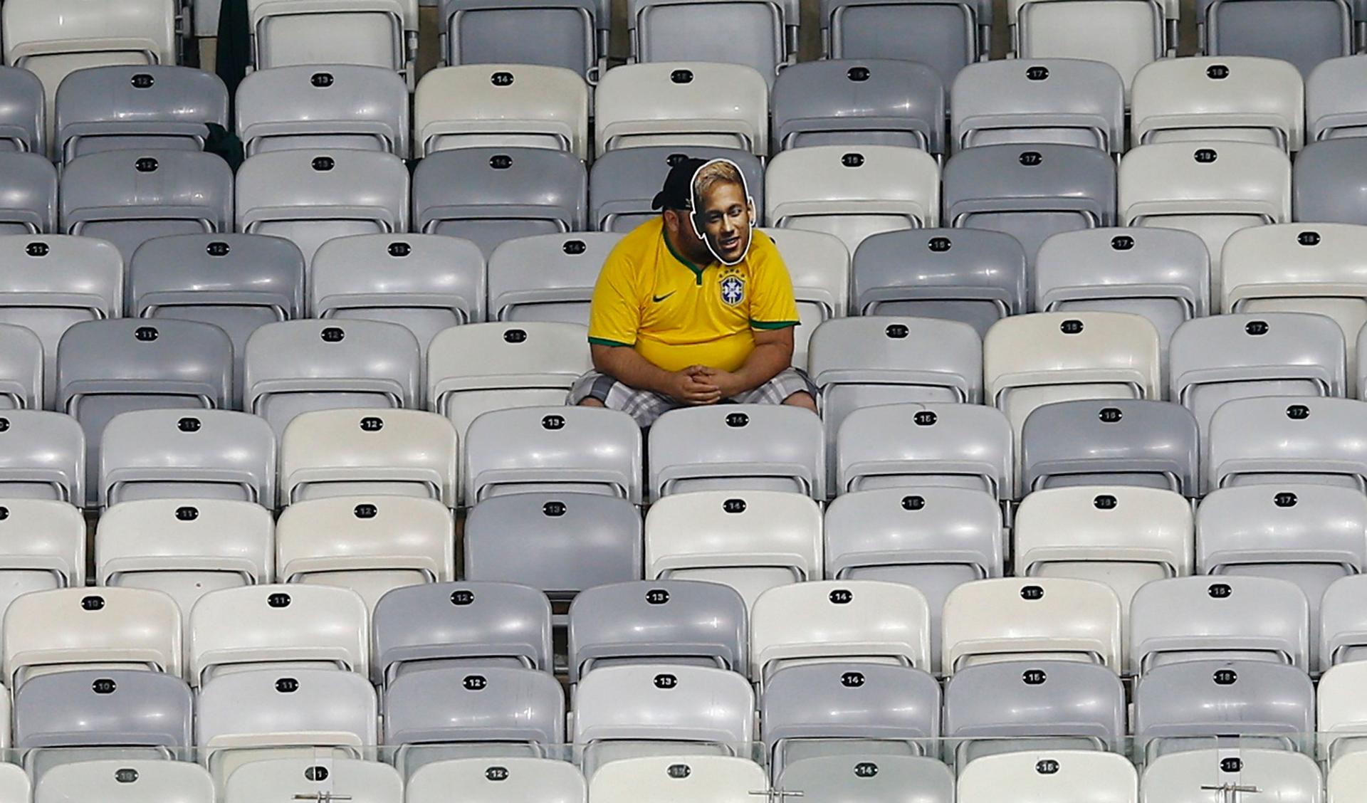 A Brazil fan sits alone in the stands at the end of the 2014 World Cup semi-finals against Germany. Fans were in a state of stunned disbelief at the most amazing World Cup result of all time.