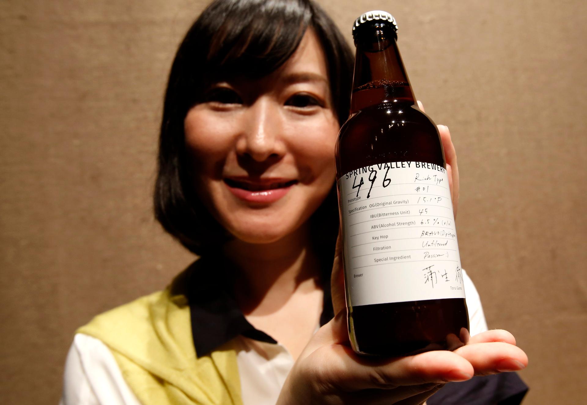 A Kirin staff member poses with its new craft beer product "Spring Valley Brewery 496 prototype," which was launched in July 2014. Craft styles are increasingly migrating from the United States to other countries.