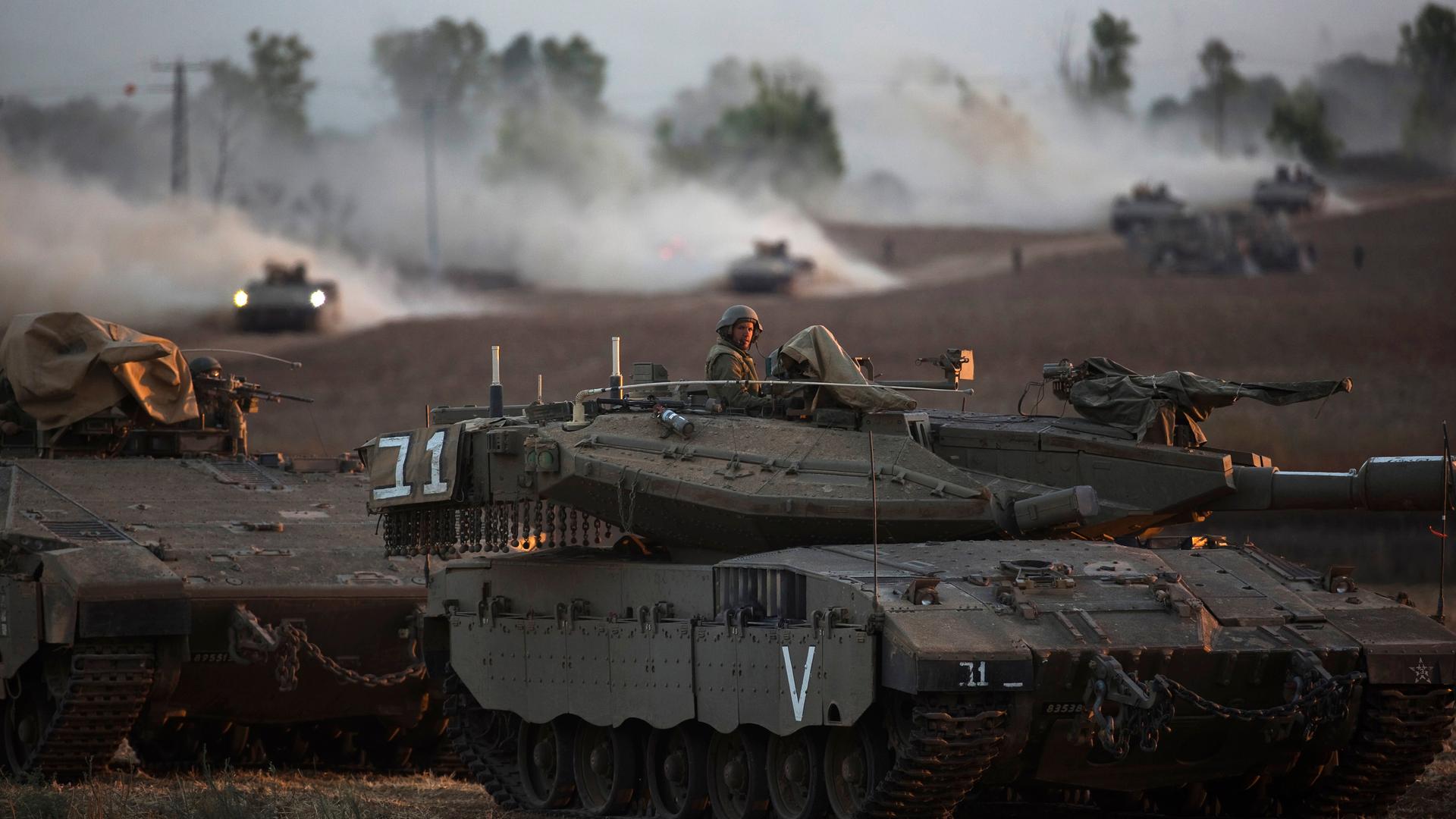 An Israeli soldier sits on top of his tank in the northern Gaza Strip.