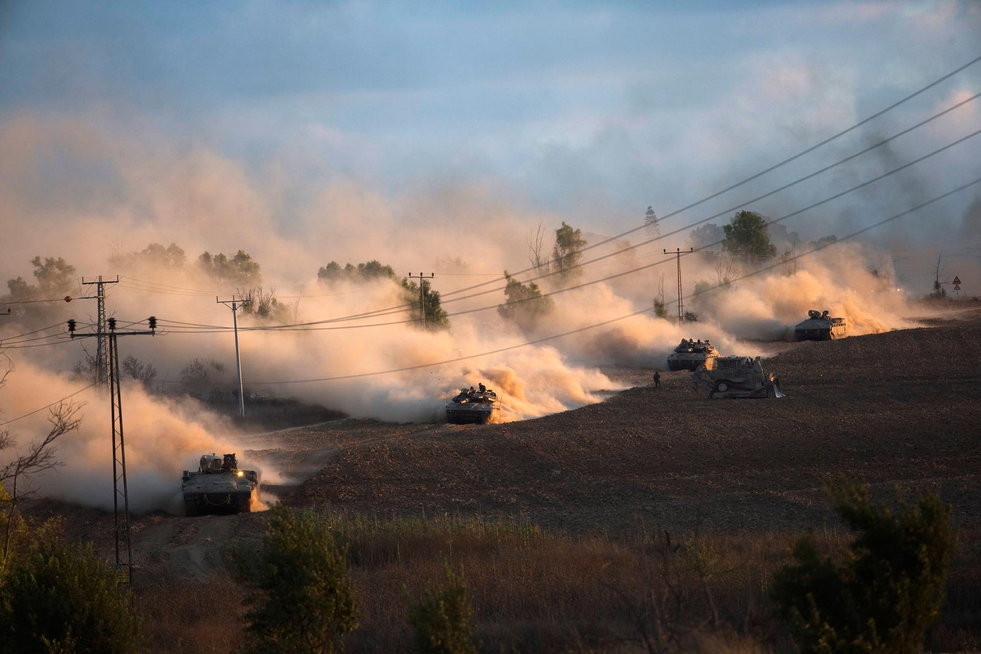Israeli tanks maneuver outside the northern Gaza Strip on July 18, 2014. Israel intensified its land offensive in Gaza with artillery, tanks and gunboats on Friday and warned it could "significantly widen" an operation Palestinian officials said was killi
