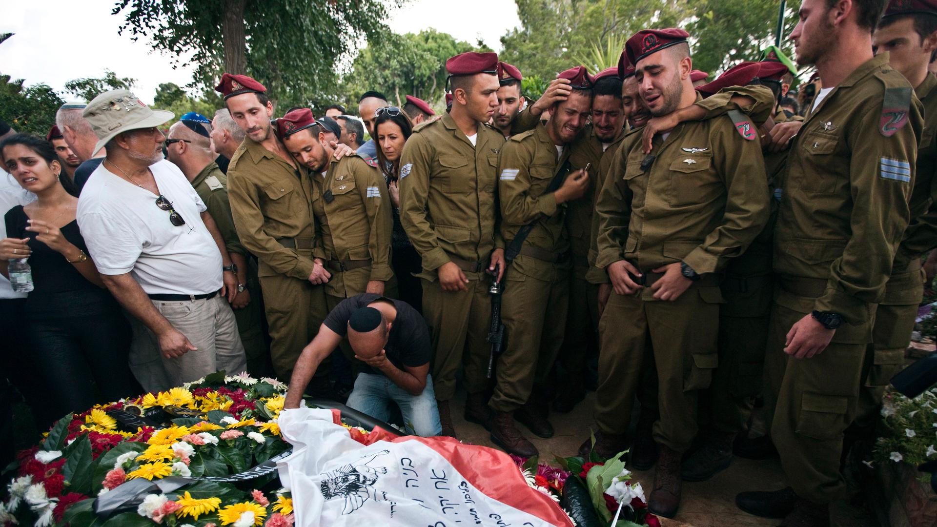 Israeli soldiers mourn the death of their fallen comrade, Bnaya Rubel during his funeral in Holon, Israel  on July 20, 2014. 
