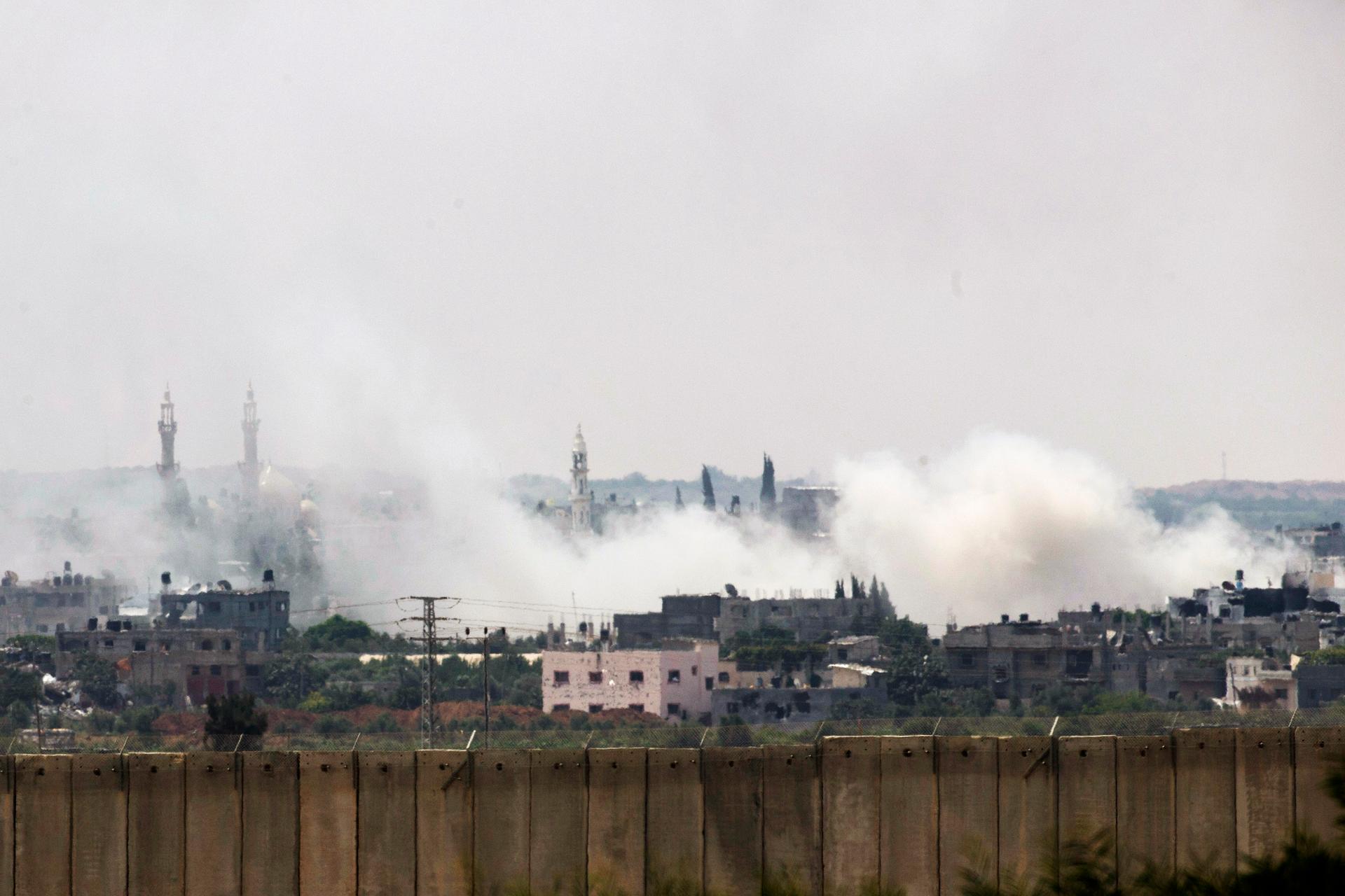 Smoke rises after an Israeli strike over the northern Gaza Strip Tuesday. Military and civilian casualties are mounting as Israeli forces push into urban areas like this.  