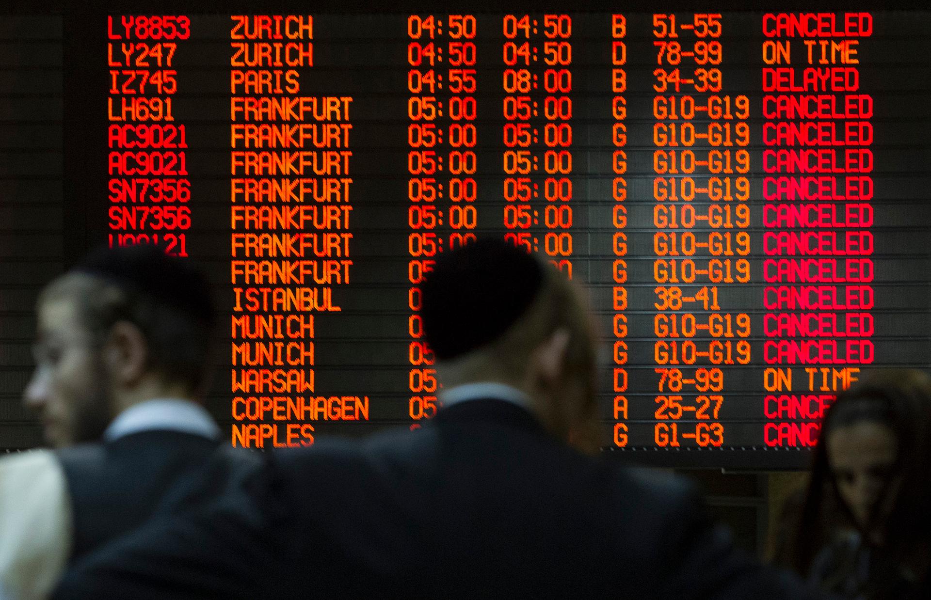 A departure board displays various cancellations at Ben Gurion International airport in Tel Aviv.