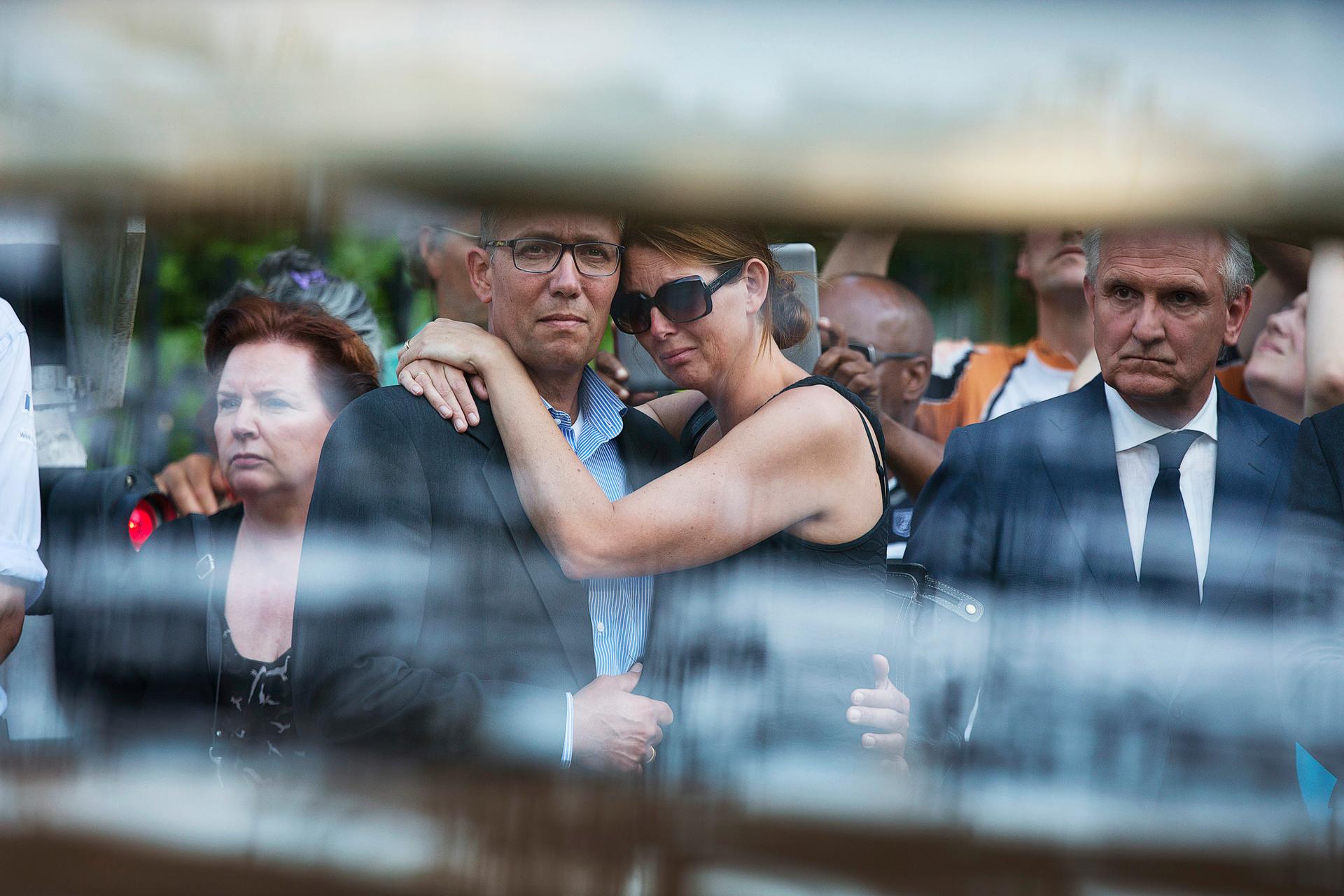 Family members of the victims killed in Malaysia Airlines Flight MH17 plane disaster are seen through the window of a hearse carrying the victims' bodies. 