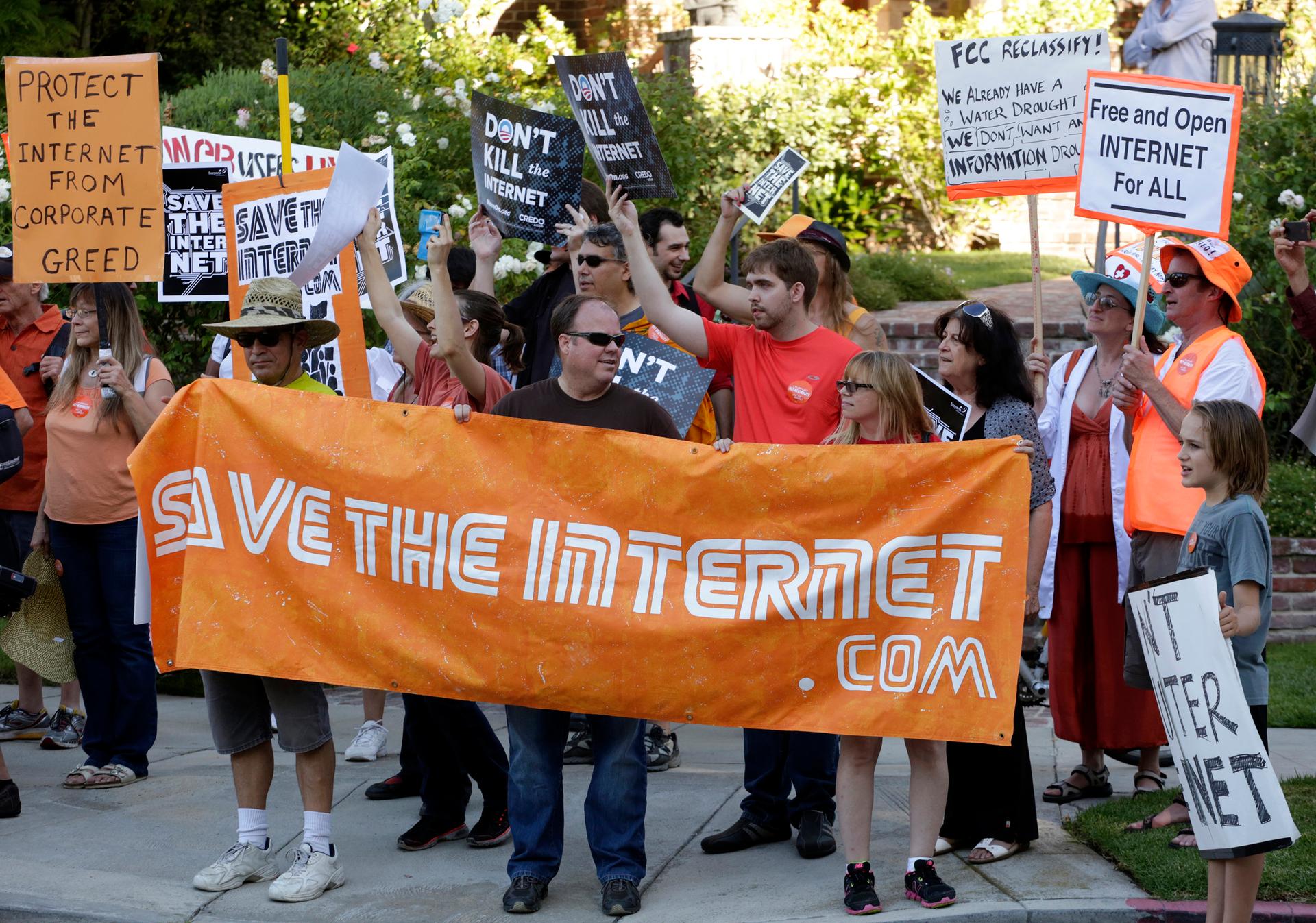 Pro-net neutrality Internet activists rally in the Los Angeles neighborhood where President Barack Obama attended a fundraiser on July 23, 2014.