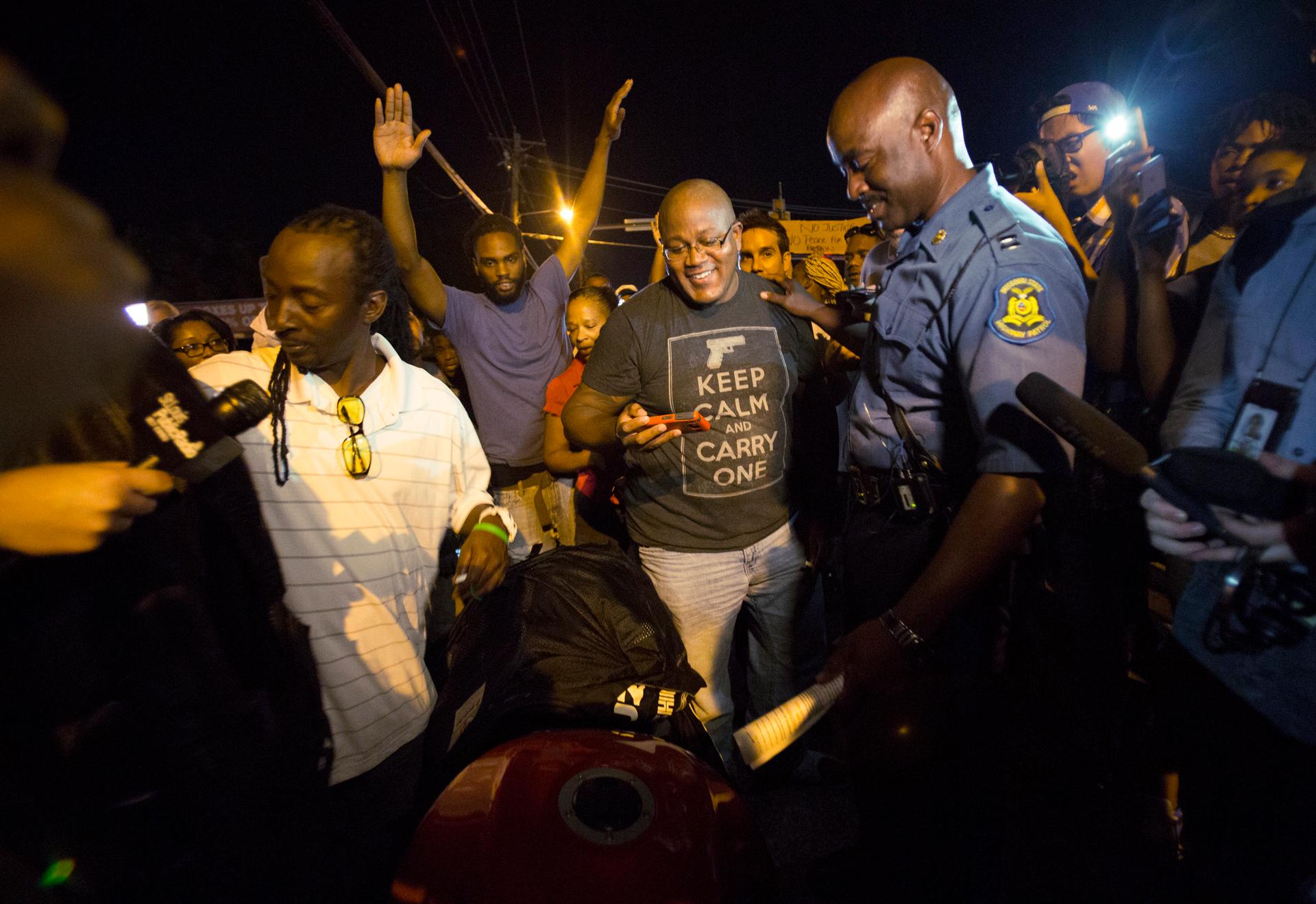 Highway Patrol Captain Ron Johnson talks to people during a peaceful demonstration, as communities react to the shooting of Michael Brown in Ferguson, Missouri, on August 14, 2014. Tensions in Ferguson eased after the Highway Patrol relieved St. Louis Cou