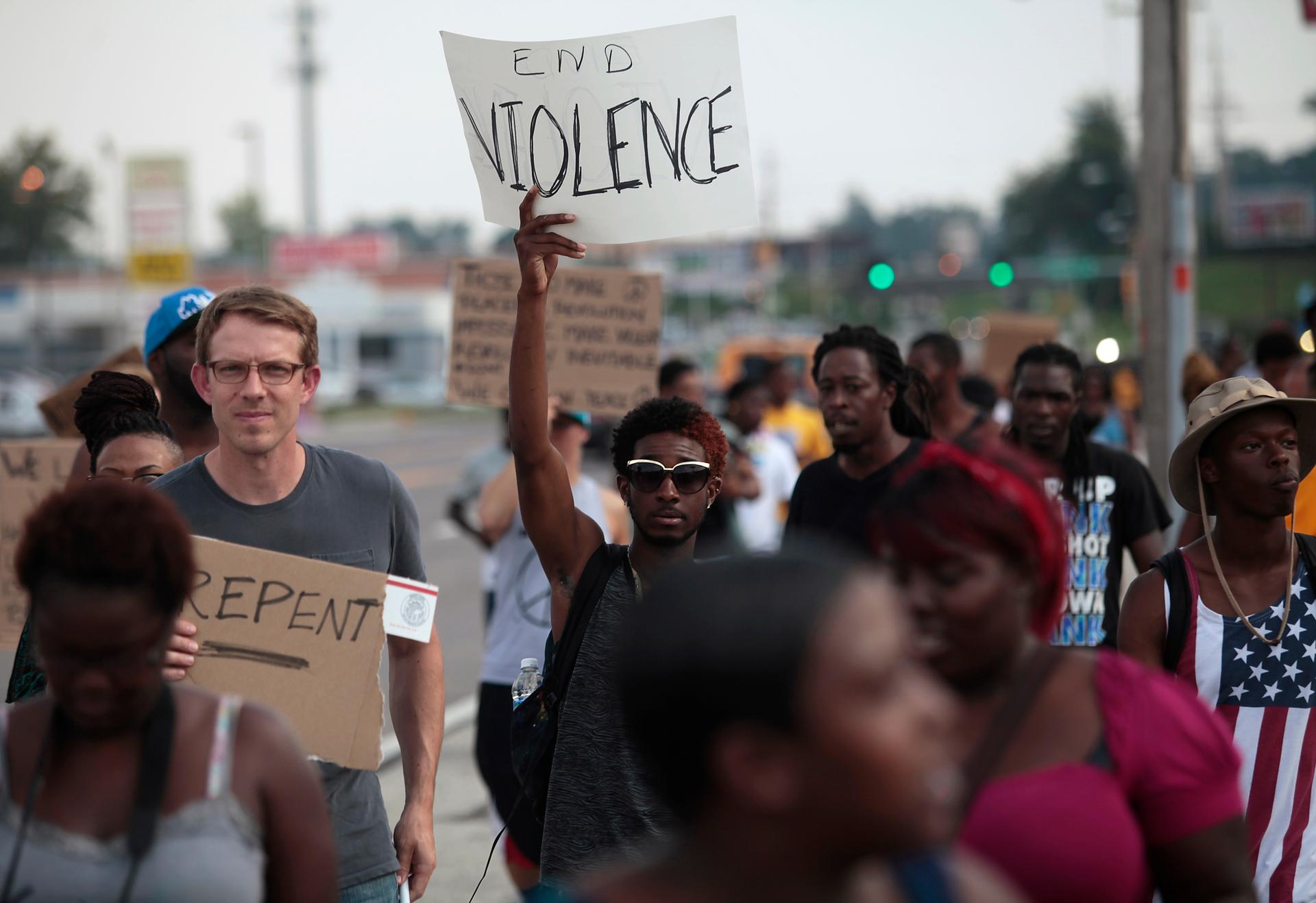 Demonstrators protest against the shooting death of Michael Brown in Ferguson, Mo., on August 18, 2014. 