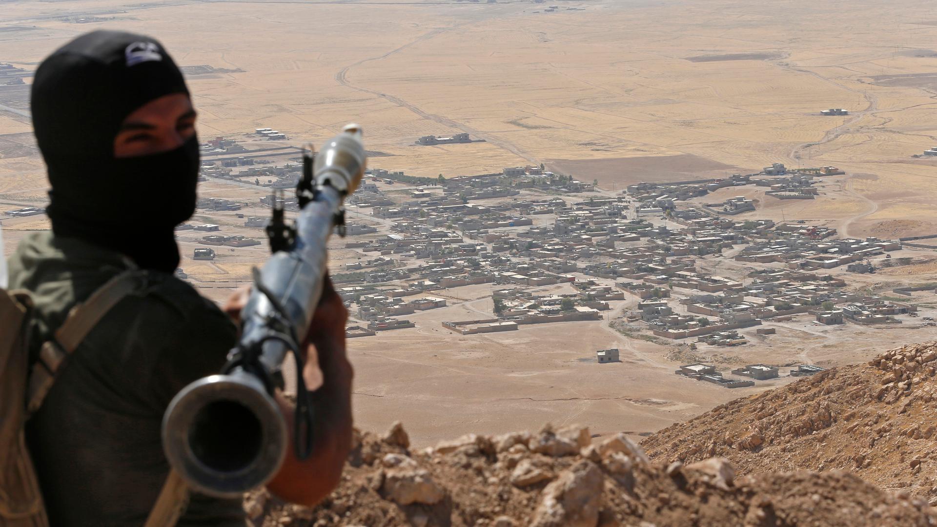 A Kurdish Peshmerga fighter looks down on Islamic State controlled territory near Mosul in 2014. Peshmerga forces this week repelled a new Islamic State offensive in the same area.