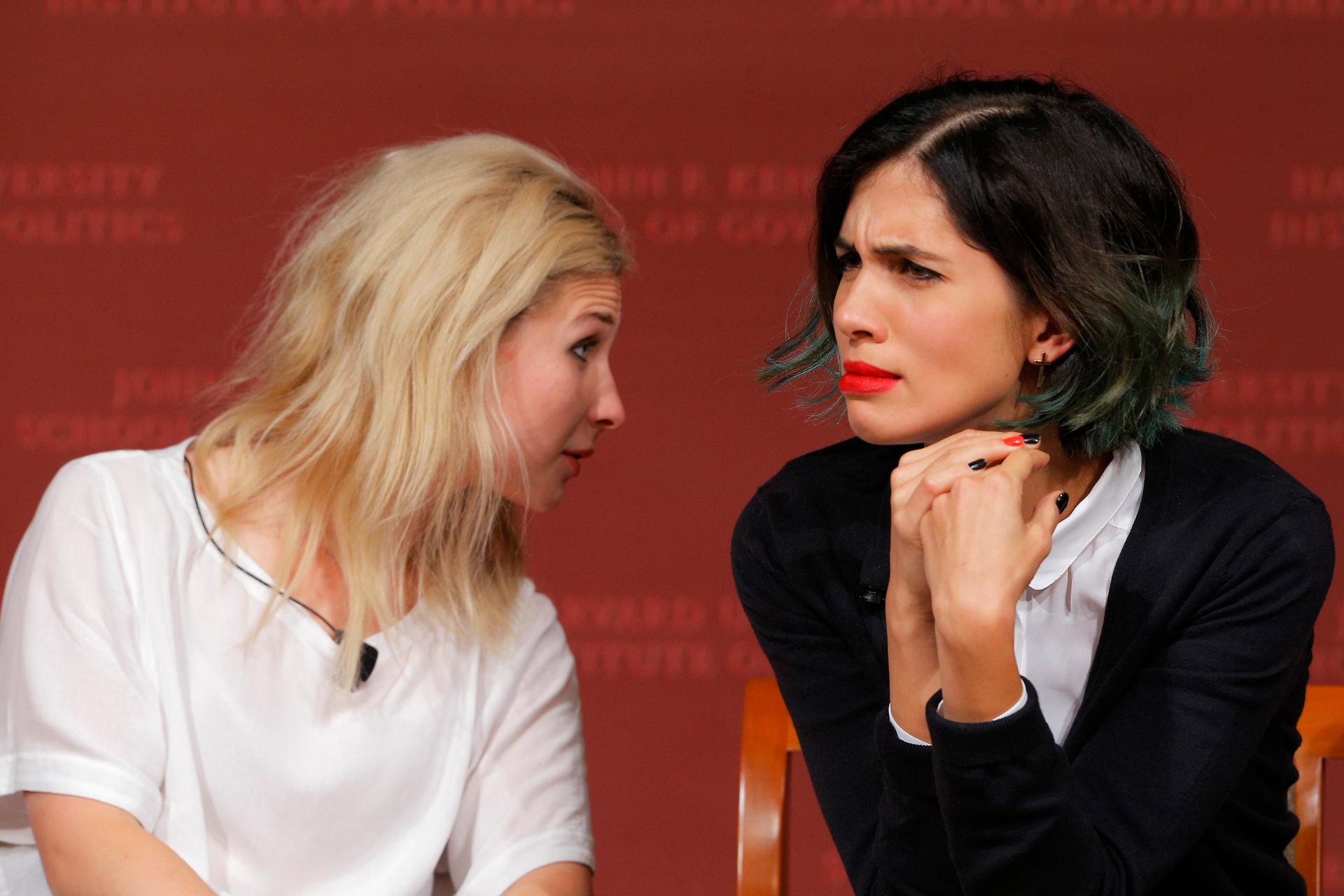 Maria Alyokhina (L) and Nadezhda Tolokonnikova, members of the punk collective Pussy Riot, listen to a question from the audience during a forum at Harvard's Kennedy School of Government, a few days before they made an appearance in Ann Arbor, MI.  
