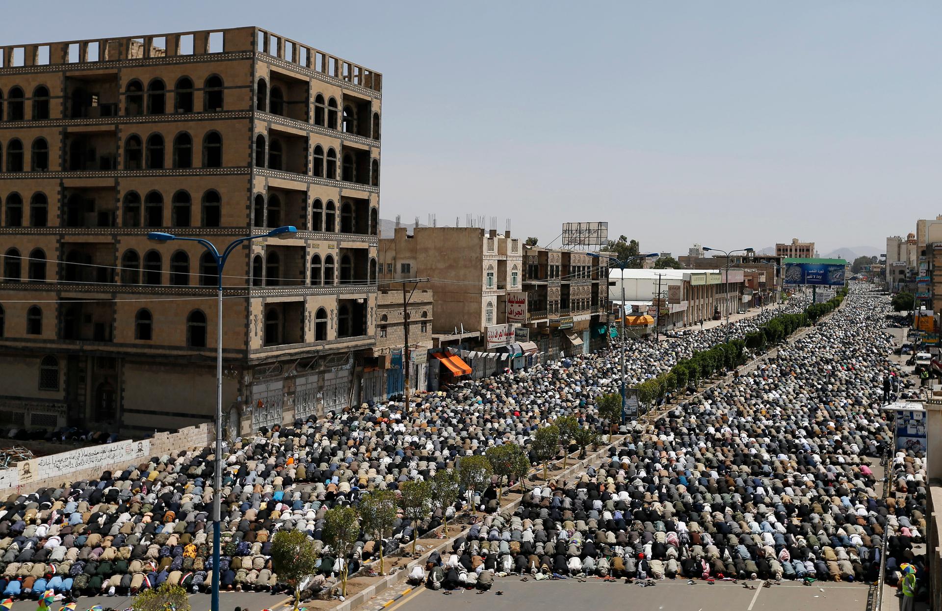 Followers of the Shi'ite Houthi movement perform Friday prayers on the airport road in Sanaa. Shiite rebels shelled Yemen's state-run television building in Sanaa on Friday and hundreds of residents fled in a dramatic escalation of violence.