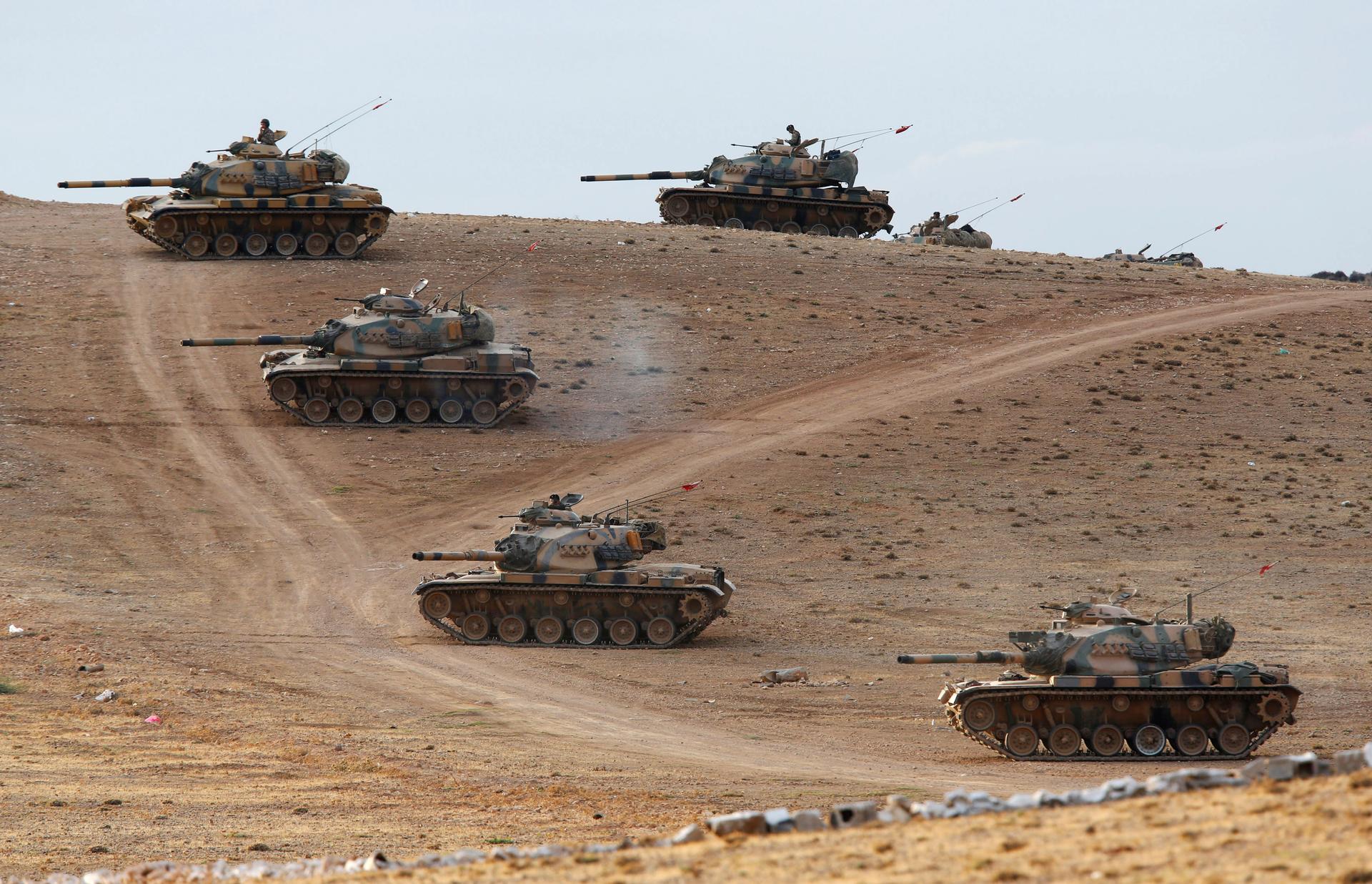 Turkish tanks taking up position on the Turkish-Syrian border on September 29, 2014, after stray fire landed on Turkish territory. Turkey is concentrating forces along the border ahead of a parliamentary debate on authorizing military intervention in Syri