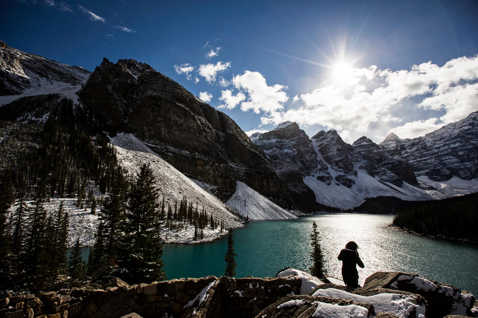 A woman looks over Moraine Lake in Banff National Park, in the Canadian Rocky Mountains, outside the village of Lake Louise, Alberta.