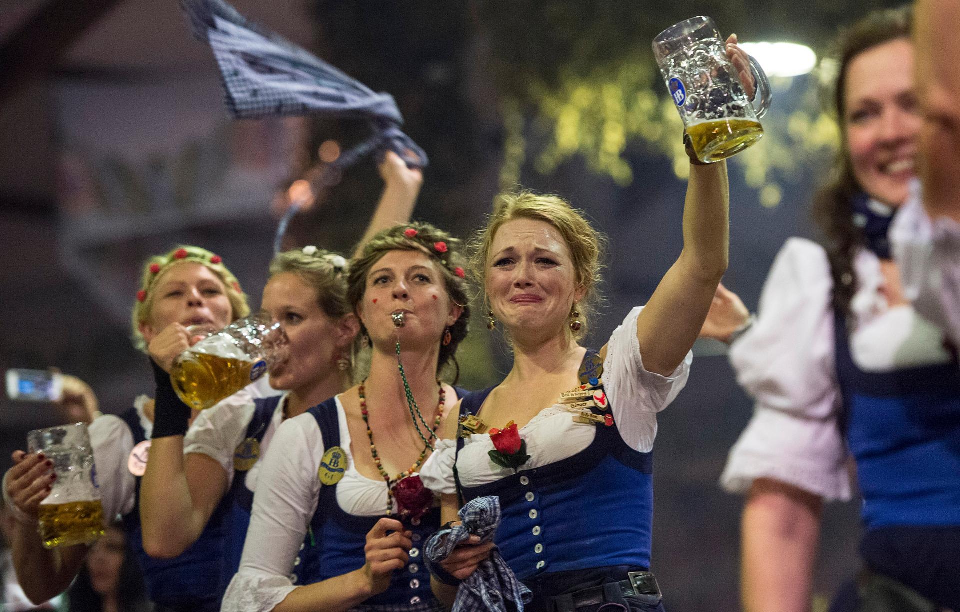 Oktoberfest waitresses celebrate the end of the world's biggest beer festival.