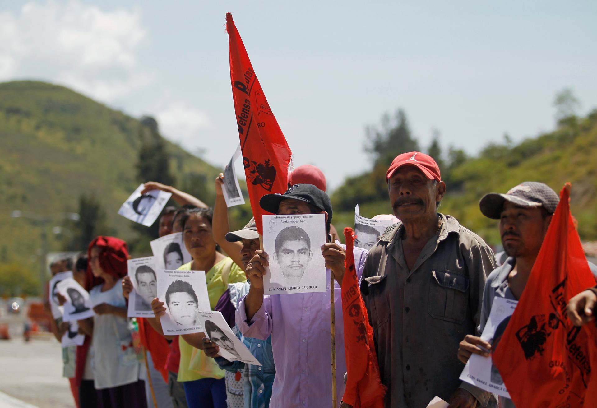Relatives hold pictures of missing students during a demonstration demanding their safe return on the outskirts of Chilpancingo, Mexico, on October 7, 2014.