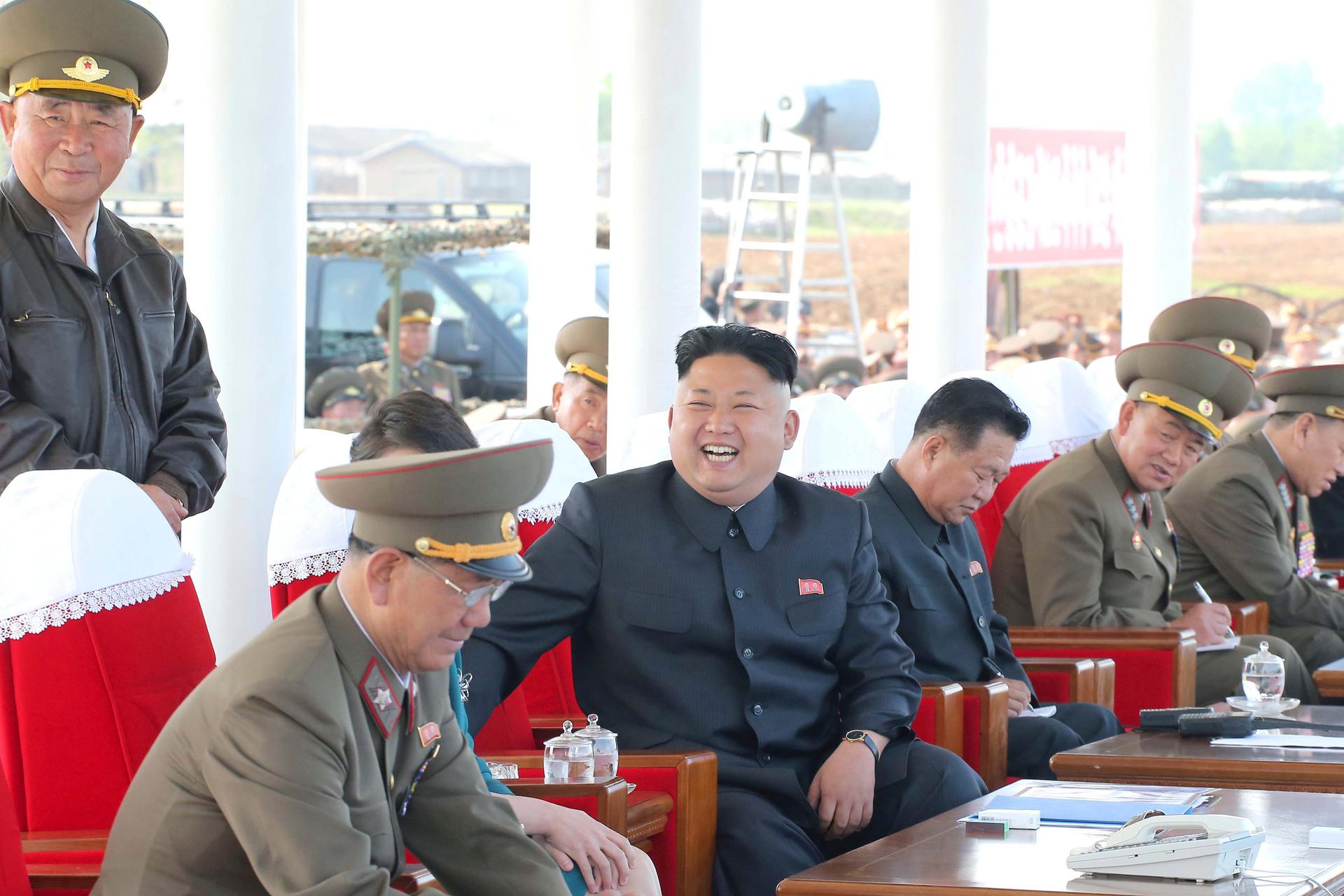 North Korean leader Kim Jong-un watches a display at a military air show with Air Force officers in May 2014.
