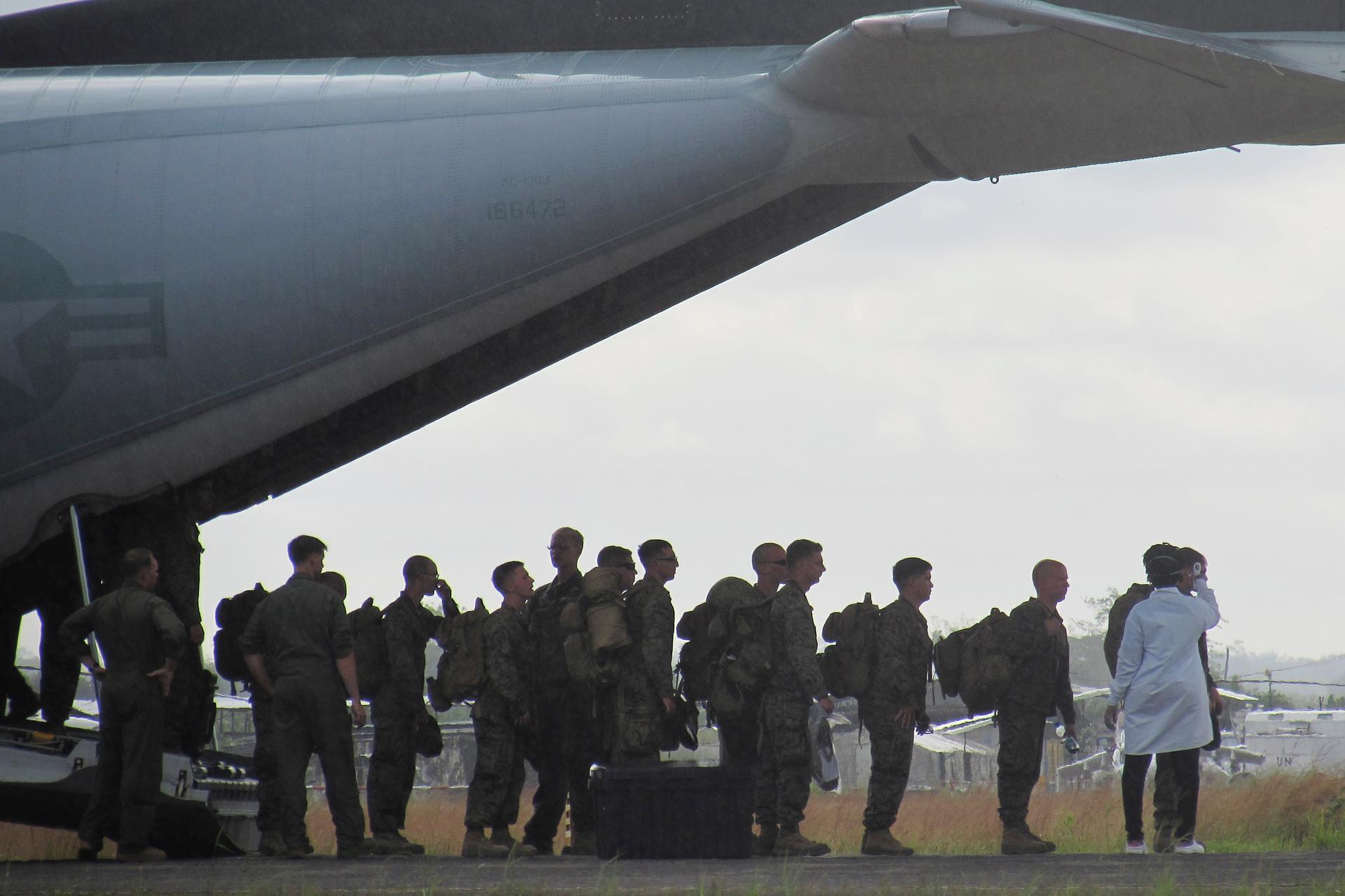 US Marines have their temperatures taken upon arrival at Roberts International airport outside Monrovia, Liberia, on October 9, 2014.