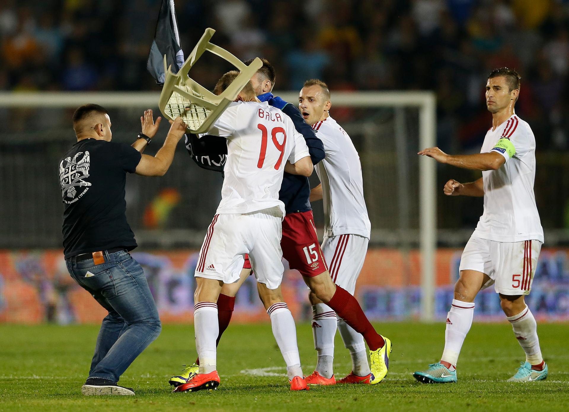 Fans and players of Serbia and Albania clash during their Euro 2016 Group I qualifying soccer match at the FK Partizan stadium in Belgrade on October 14, 2014. 