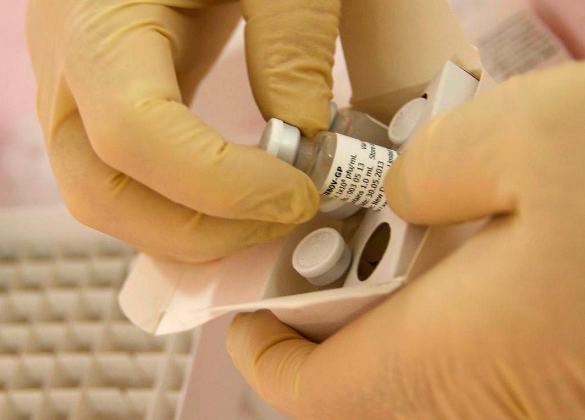 Scientists at the National Microbiology Lab in Winnipeg, Manitoba, prepare an experimental Ebola vaccine for shipment to the World Health Organization.