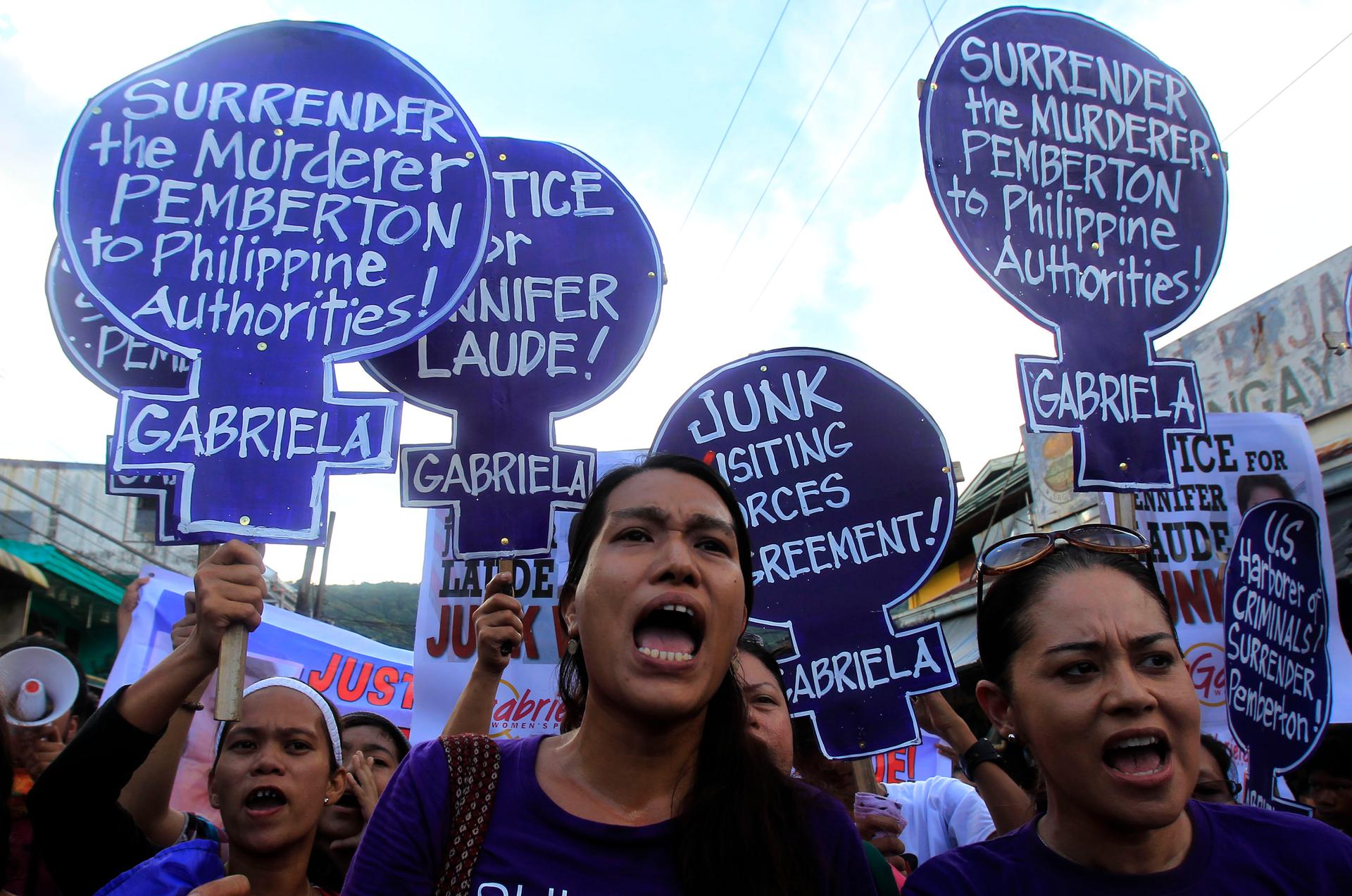 Members of the Gabriela Women's Party, a group advocating the rights of Filipino women, shout "Justice for slain transgender Jennifer Laude" during a protest in Olongapo City, north of Manila, on October 21, 2014. 