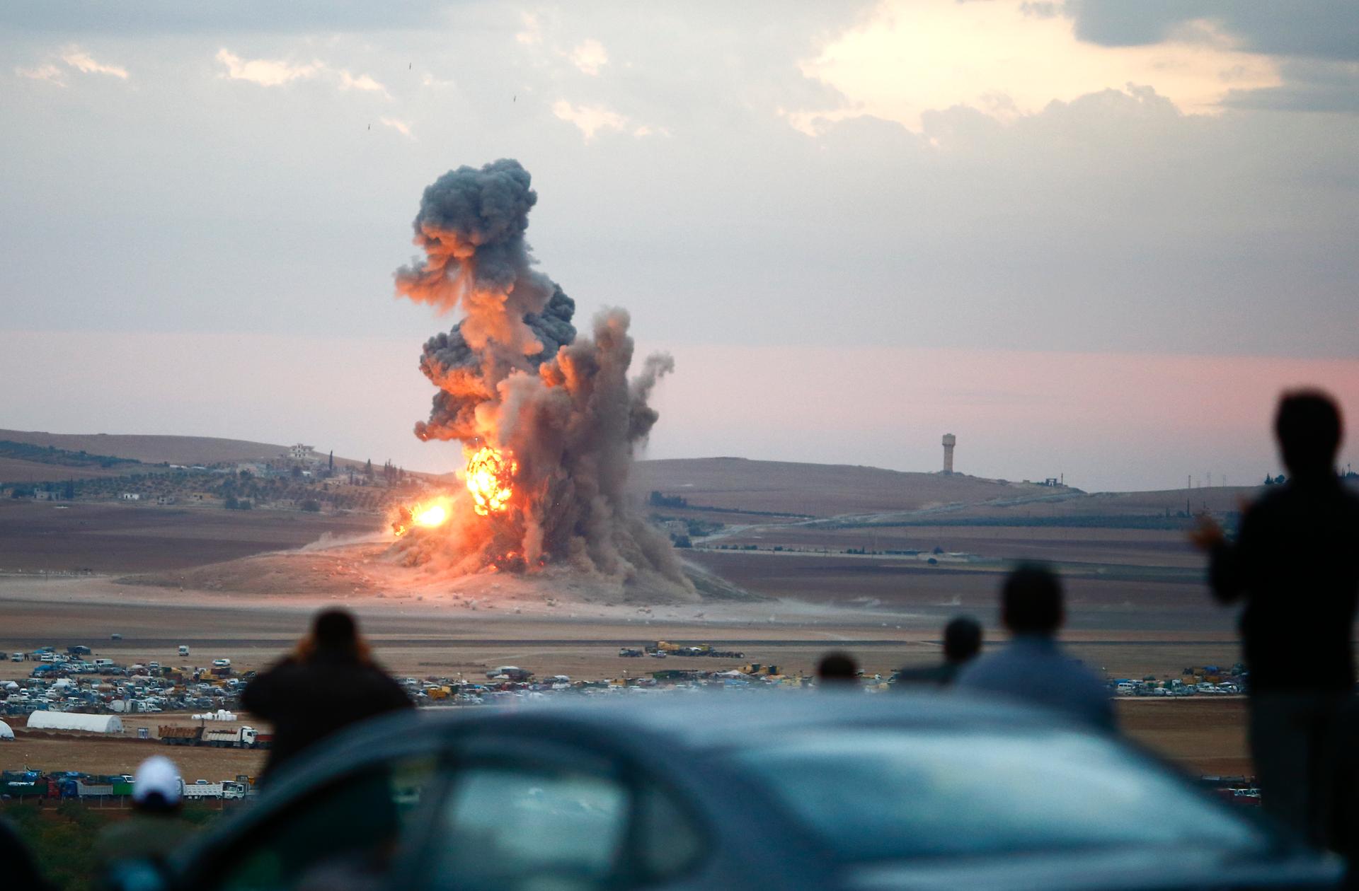 Smoke and flames rose over a hill after air strikes near the Syrian town of Kobani last year. 