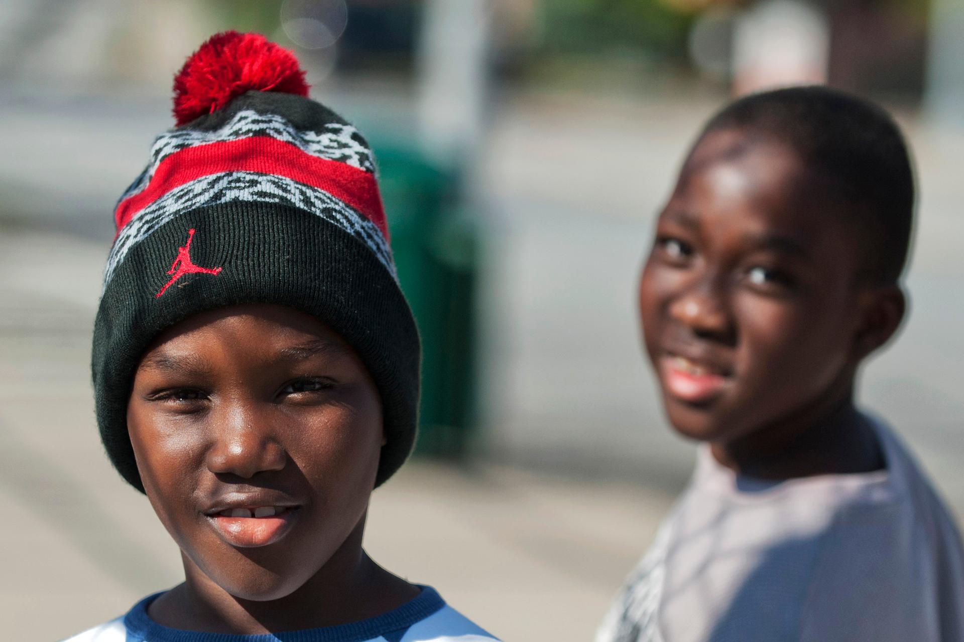 Young residents pose for a photograph on a street in the Clifton neighborhood of Staten Island in New York on October 25, 2014. The area is home to a community known as "Little Liberia" — it has the largest concentration of Liberians outside of Africa.