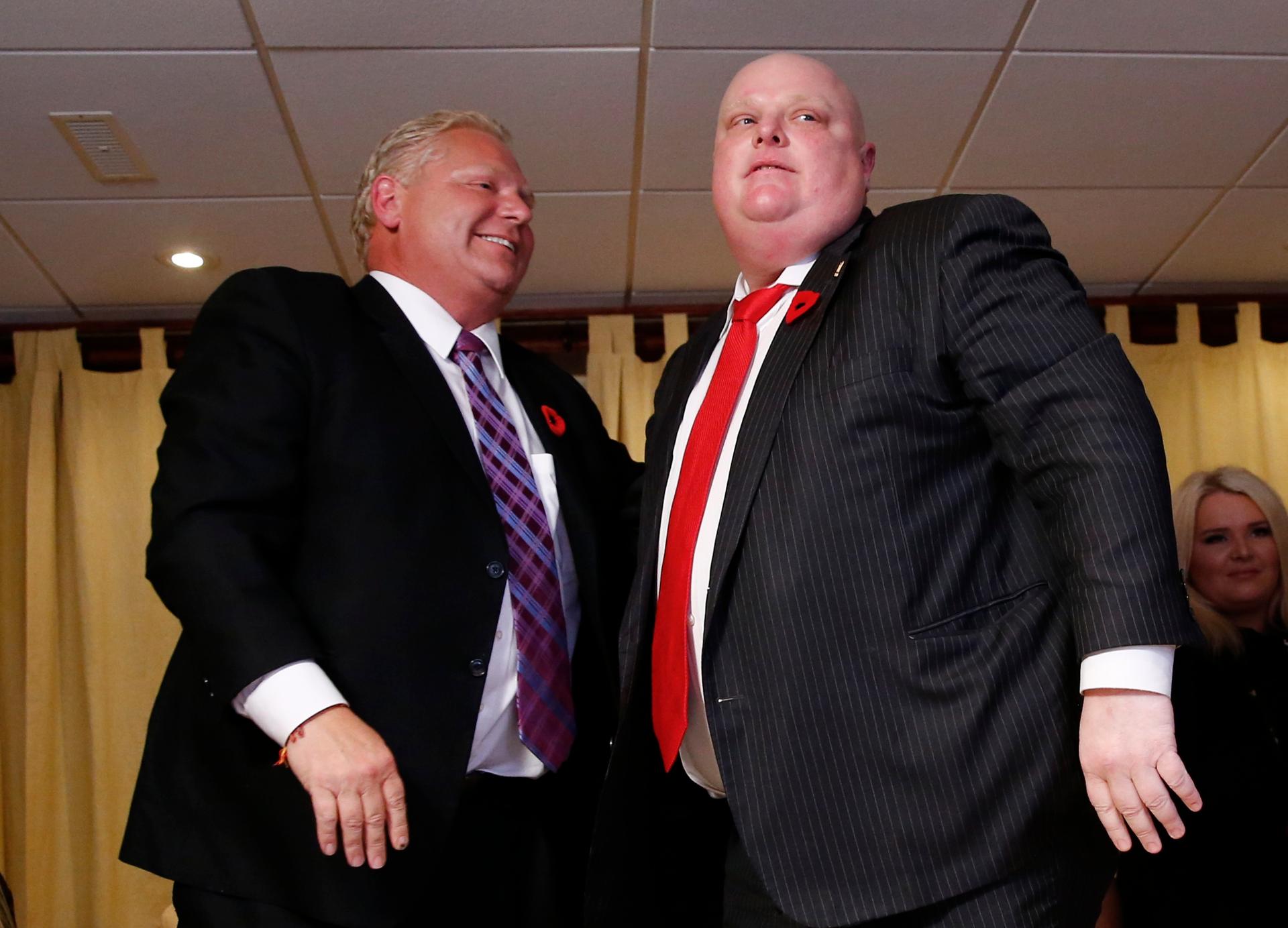 Mayor Rob Ford (R) is congratulated by his brother Doug after it was announced that Rob was elected as a city councillor and that Doug was stopped in his bid to become mayor in the municipal election in Toronto, October 27, 2014. 
