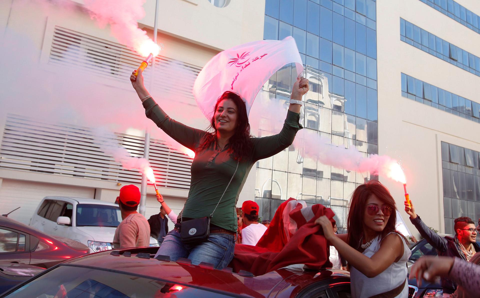 Supporters of the secular Nida Tounes (Call of Tunisia) party movement wave flags and shout slogans during parliamentary elections.