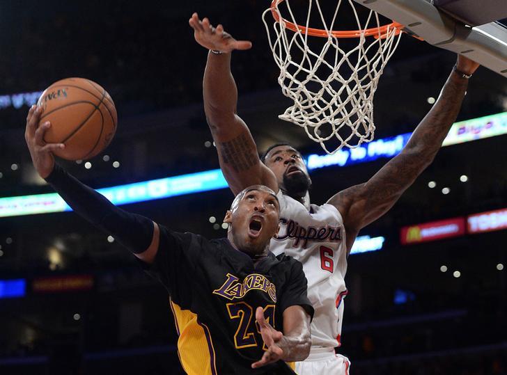 Los Angeles Lakers guard Kobe Bryant (24) gets by Los Angeles Clippers center DeAndre Jordan (6) for a basket in the second half of the game at Staples Center. ​Oct 31, 2014; Los Angeles.
