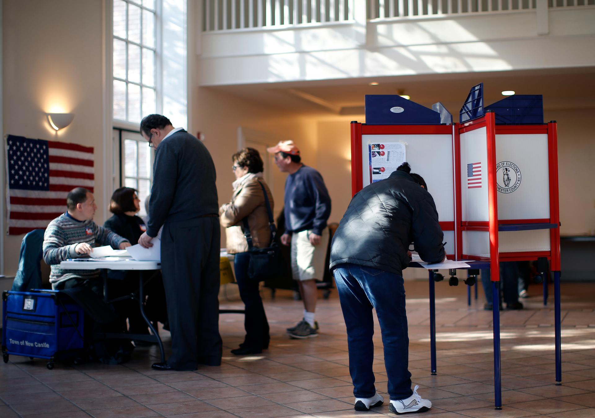Voters sign in and fill out ballots and at a polling station at the Presbyterian Church in the town of Mount Kisco, New York, on November 4, 2014. Americans were heading to the polls Tuesday in the midterm elections.