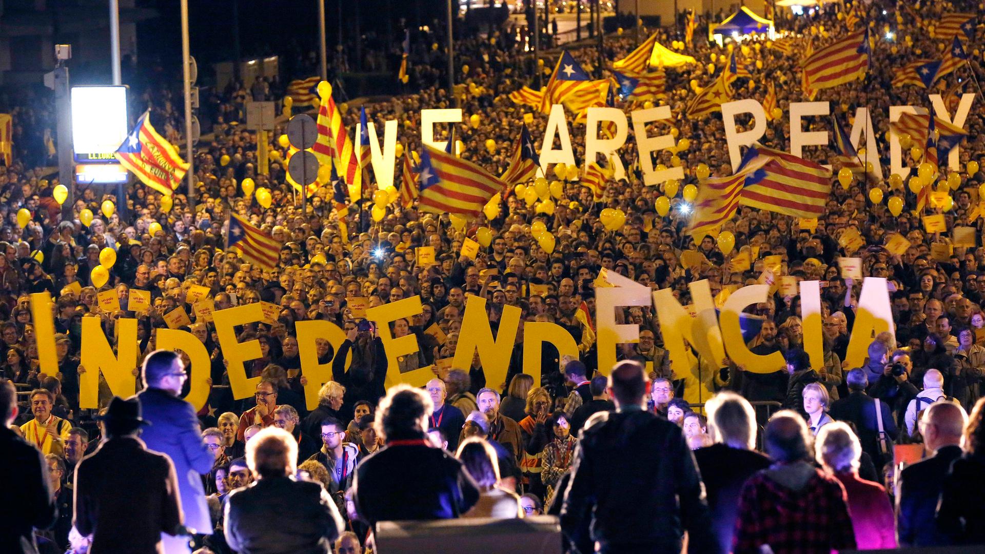 Pro-independence Catalonians hold up giant letters reading "We are ready, Independence" during the final meeting before a ceremonial referendum in Barcelona on November 7, 2014. 