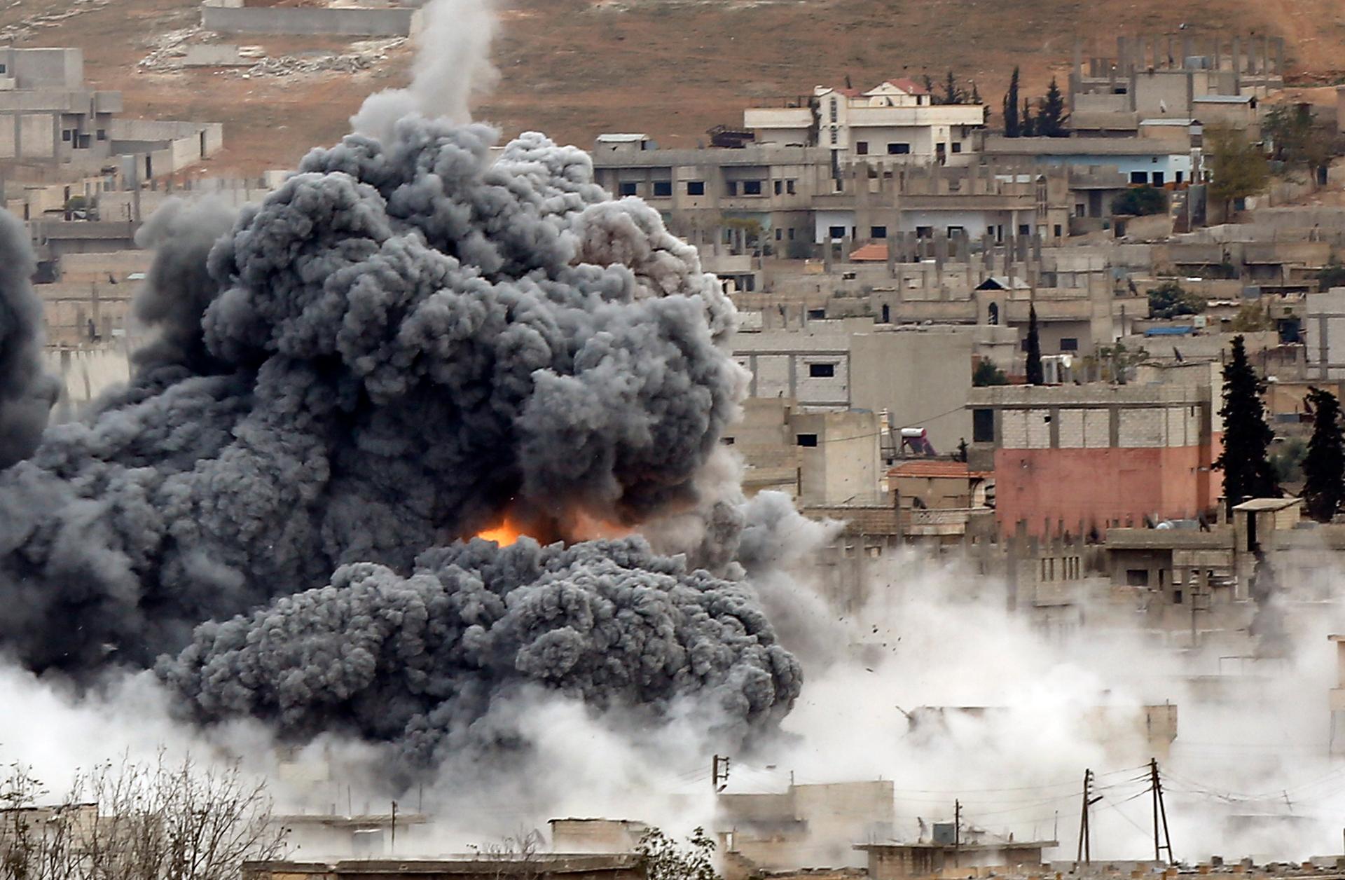 An explosion following an air strike on Novemeber 17th is seen in central Kobane, northern Syria. Picture taken from the Turkish side of the Turkish-Syrian border. 
